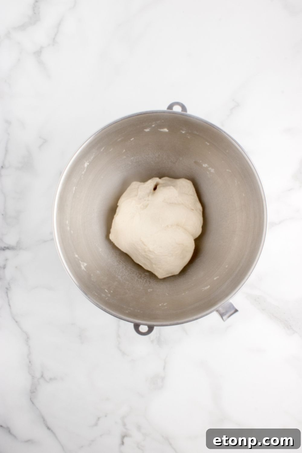 roll dough in a metal bowl on table 
