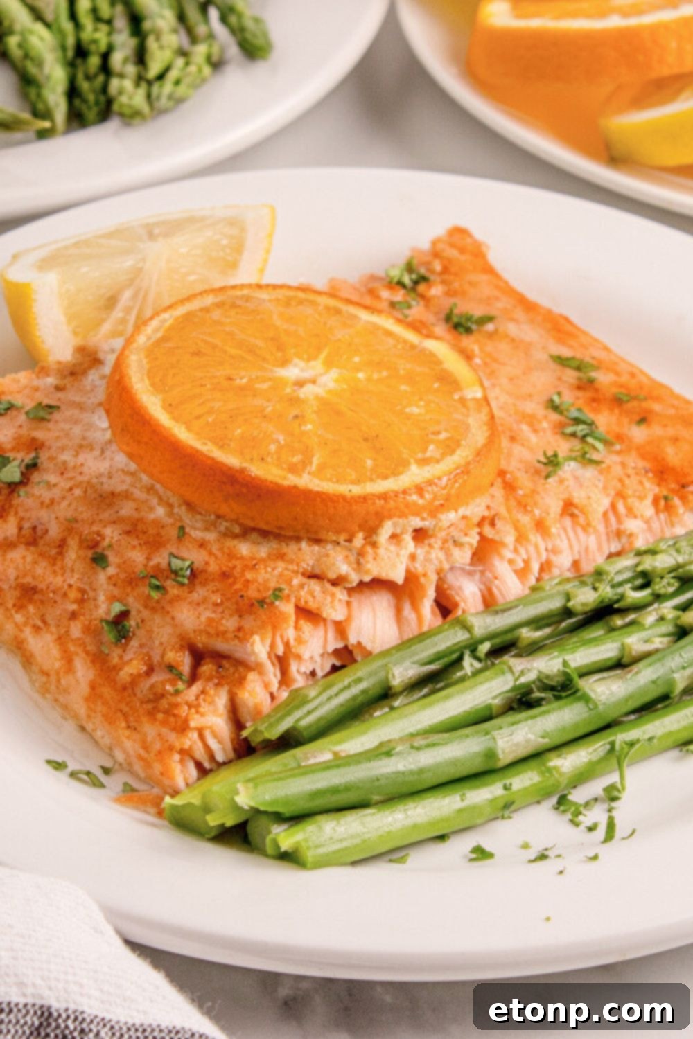Simple Grilled Honey Mustard Salmon Foil Packets 19 Grilled Honey Mustard Salmon on plate with asparagus and lemon wedge to side of plate
