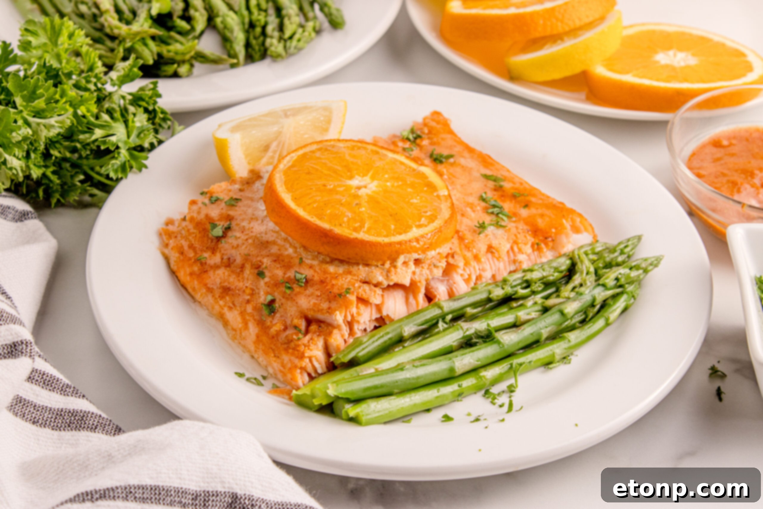 Simple Grilled Honey Mustard Salmon Foil Packets 22 Grilled Honey Mustard Salmon on a white plate with asparagus and citrus wedges