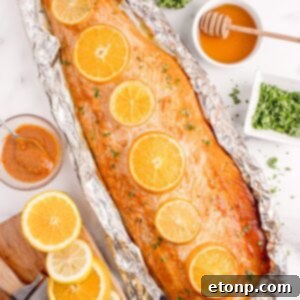 Simple Grilled Honey Mustard Salmon Foil Packets 24 Grilled Honey Mustard Salmon in Foil on table with honey, citrus wedges, etc.