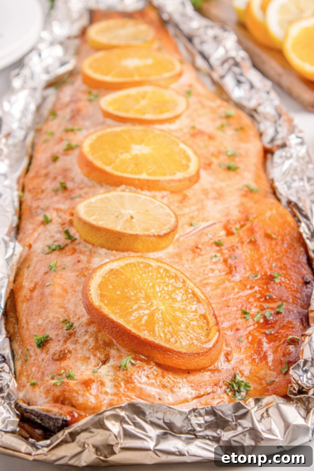 Simple Grilled Honey Mustard Salmon Foil Packets 4 Grilled Honey Mustard Salmon in Foil sitting on table with oranges to side of table