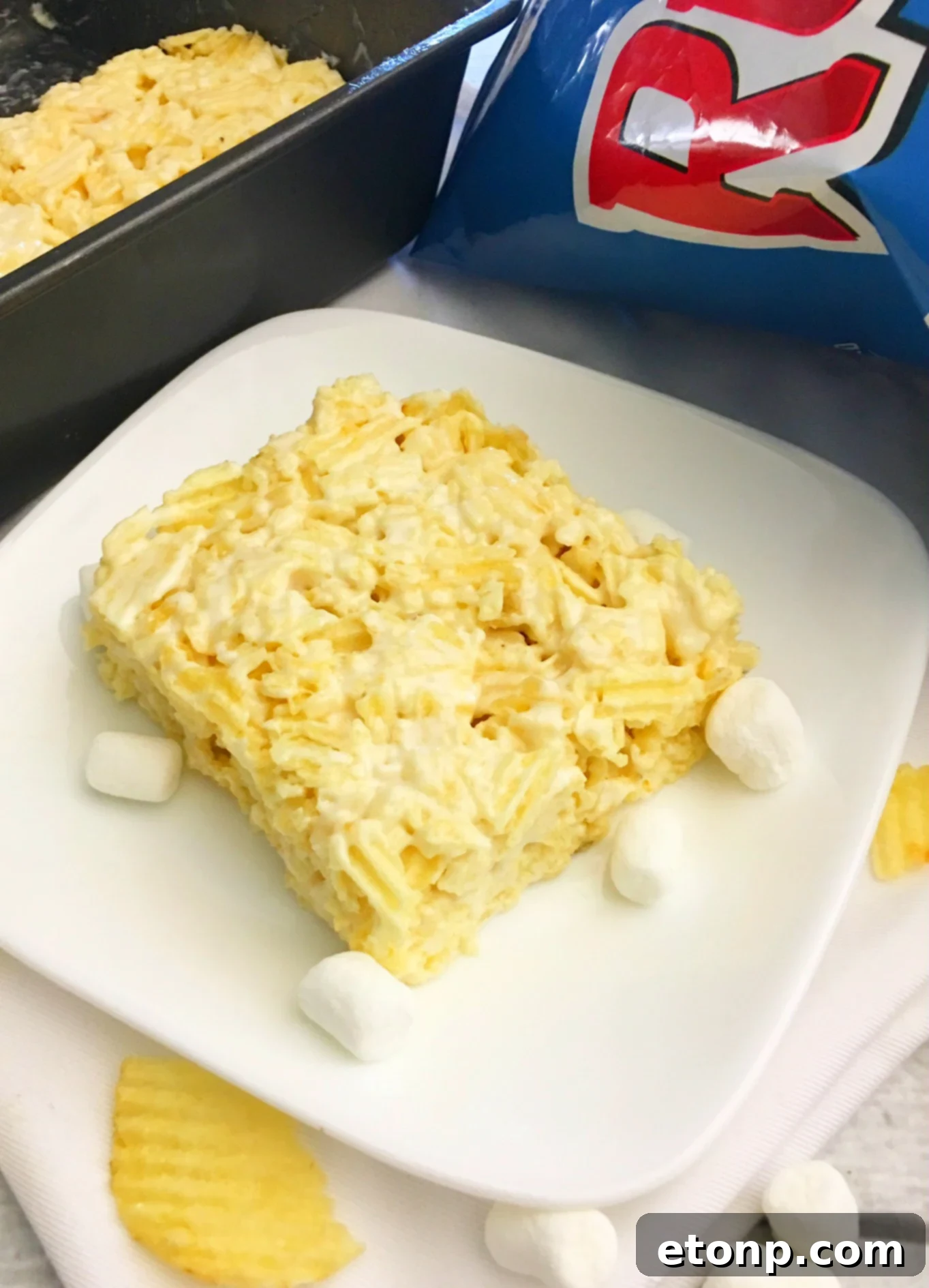Close-up shot of a single Ruffles Krispie Treat, highlighting the crispy chip pieces and marshmallow coating.