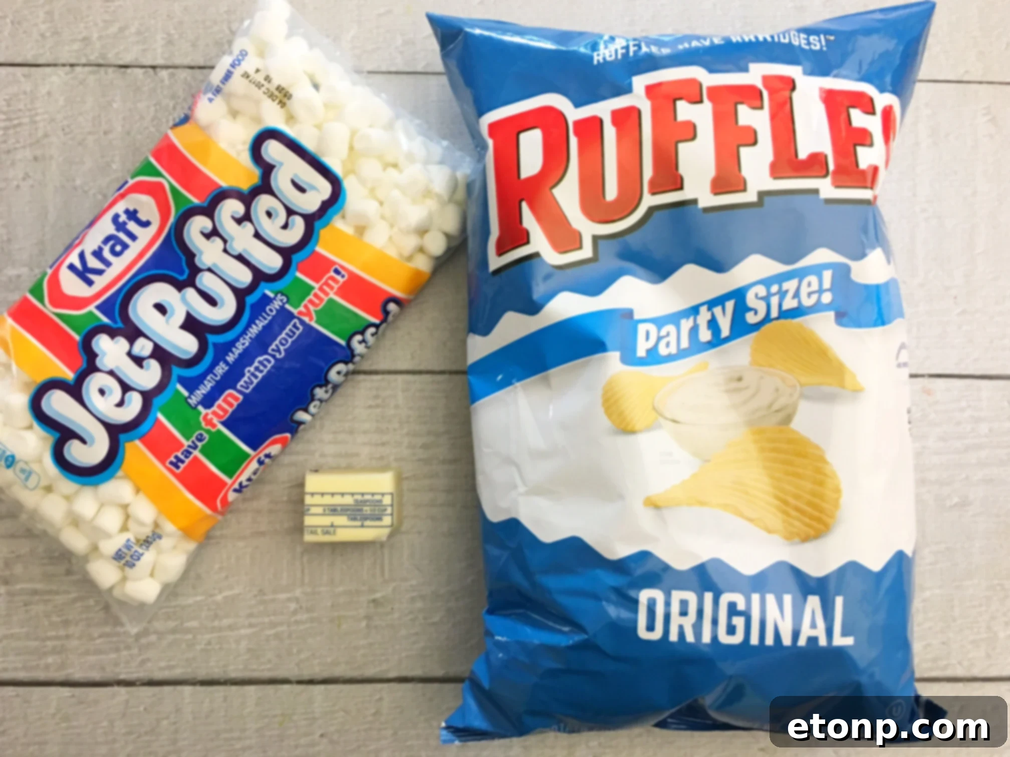 Stack of Ruffles Krispie Treats squares on a rustic wooden board, showcasing their appealing golden color and snackable size.