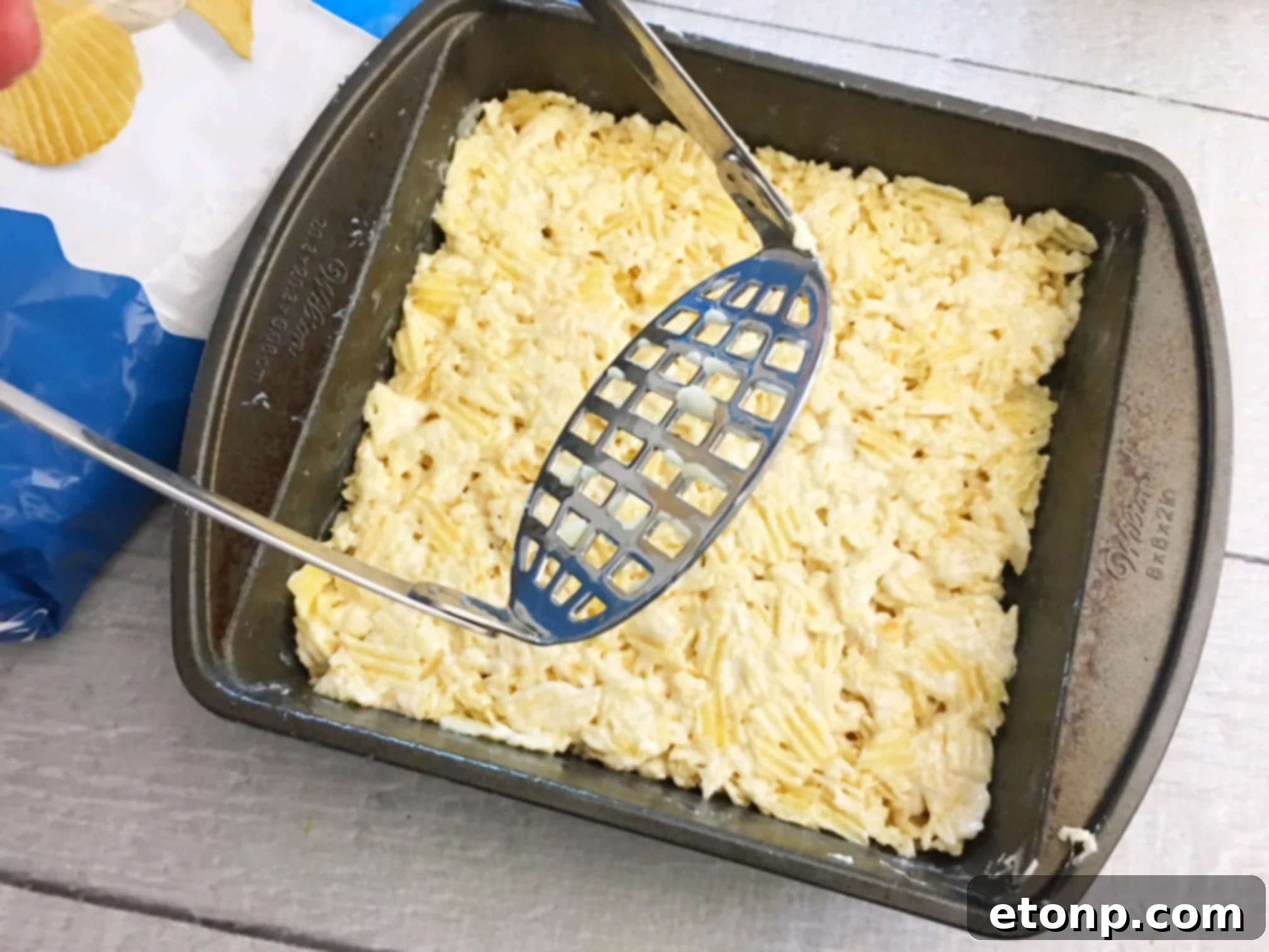 Ingredients for Ruffles Krispie Treats laid out: a bag of Ruffles chips, miniature marshmallows, and butter.