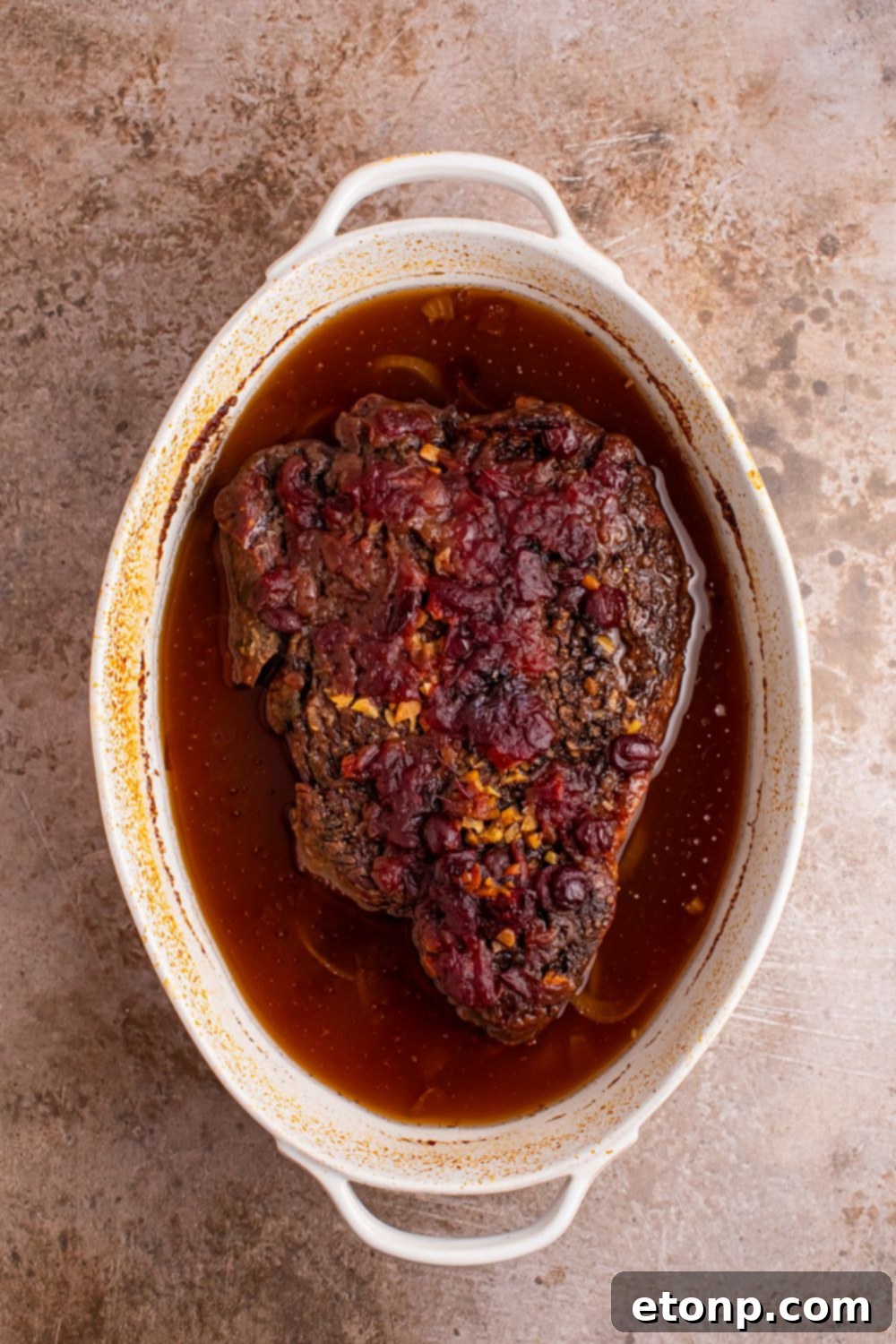 baked Cranberry Pot Roast in a casserole dish on table 