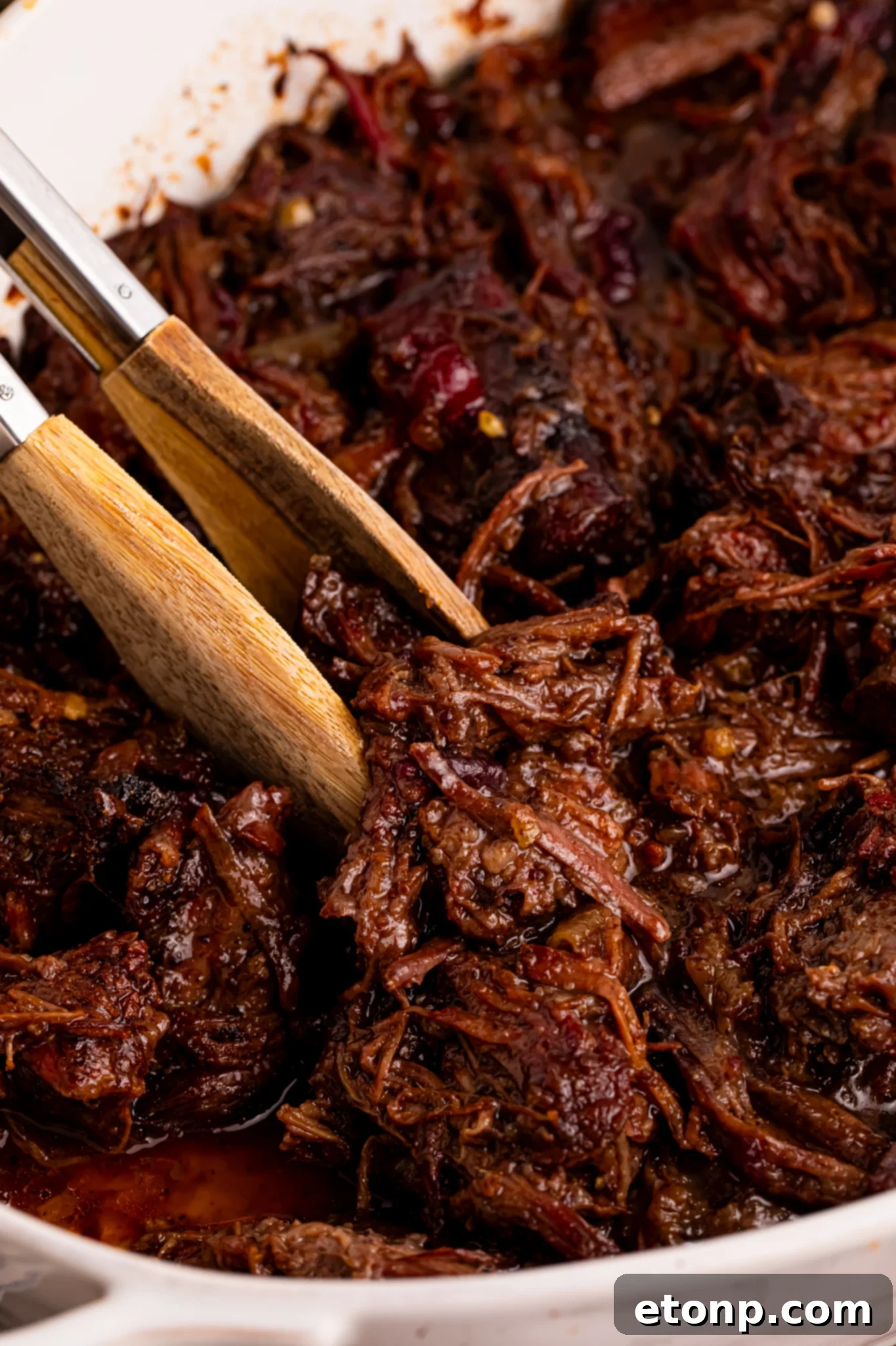 Cranberry Pot Roast shredded in a baking dish 