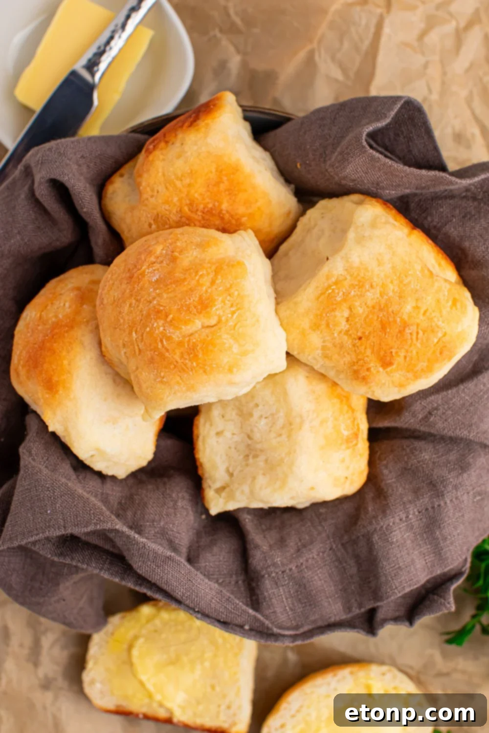 2 Ingredient Dinner Rolls in a basket on table with butter to side of basket 