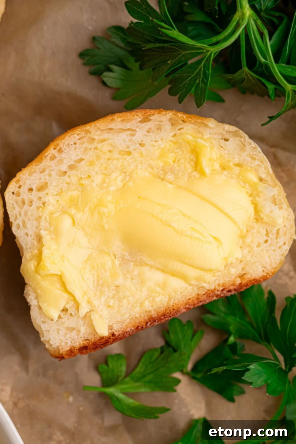 2 Ingredient Dinner Roll on table slathered with butter 