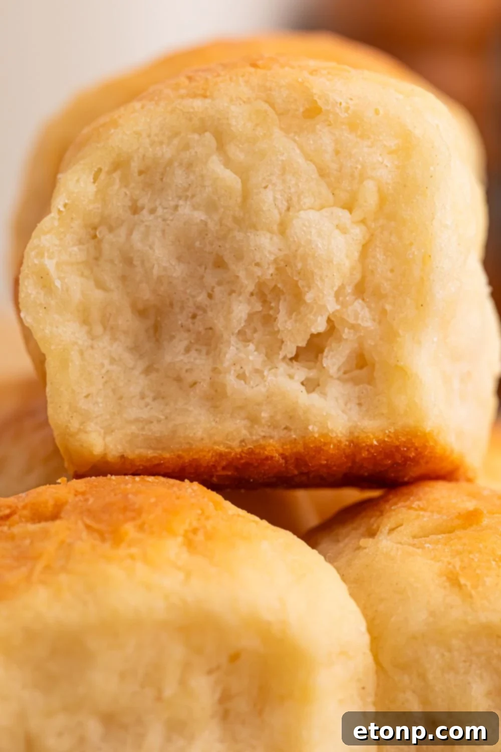 close up of 2 Ingredient Dinner Rolls stacked on top of one another on table 
