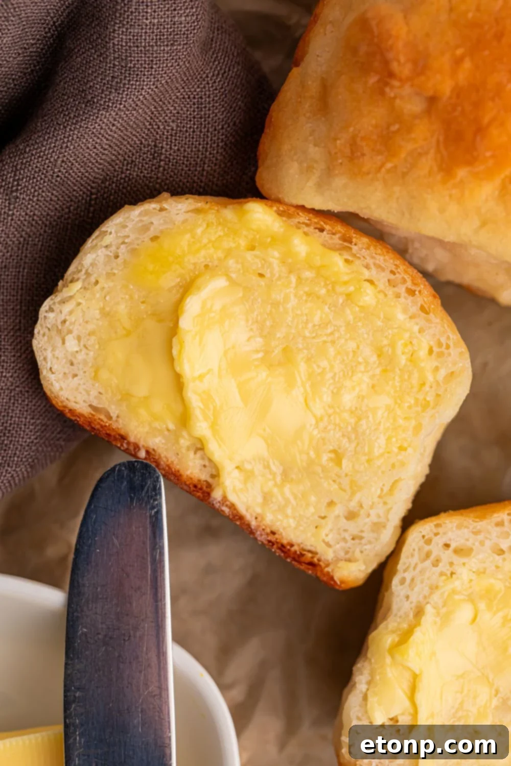 2 Ingredient Dinner Rolls on table that are spread with butter