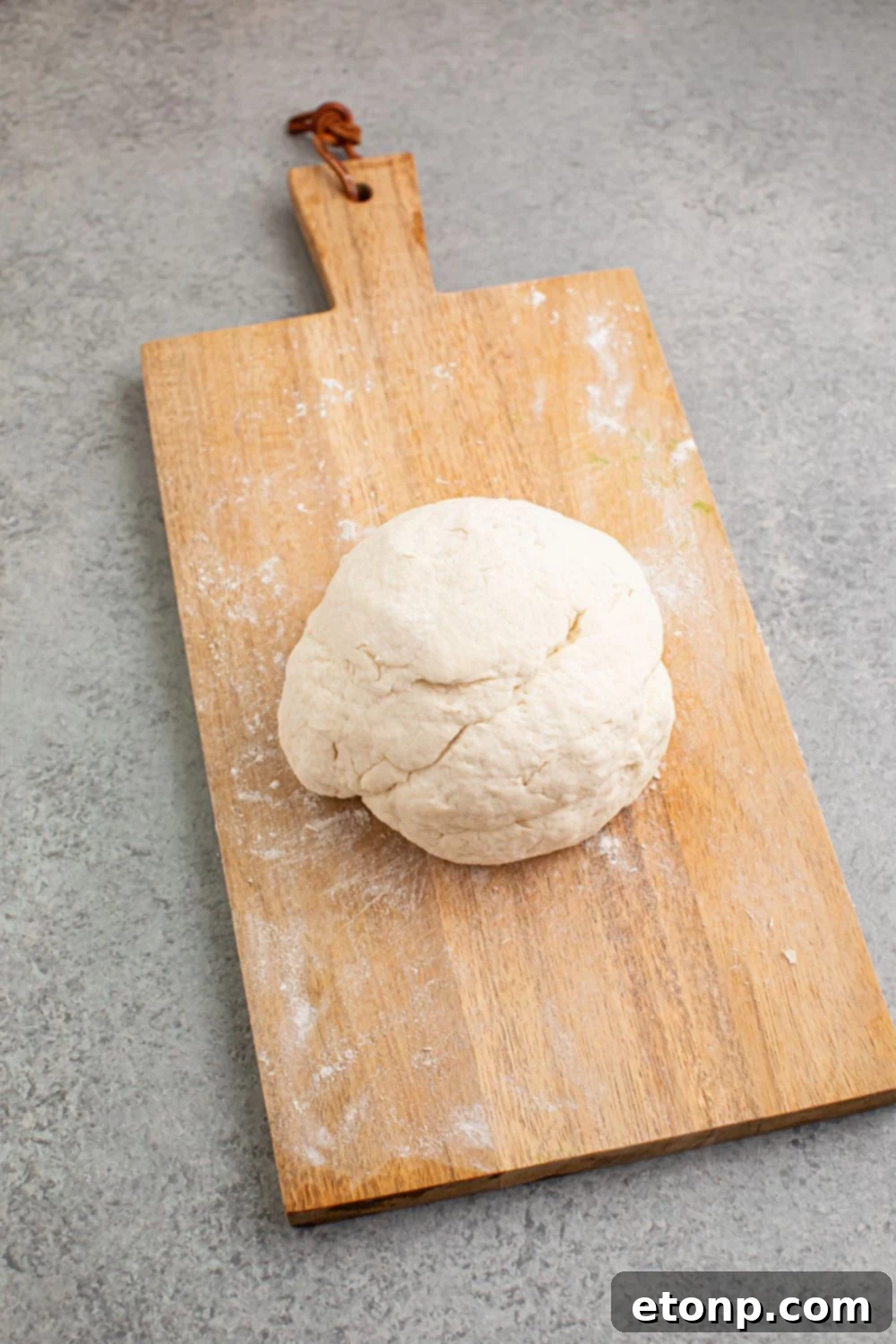 large dough ball on cutting board 