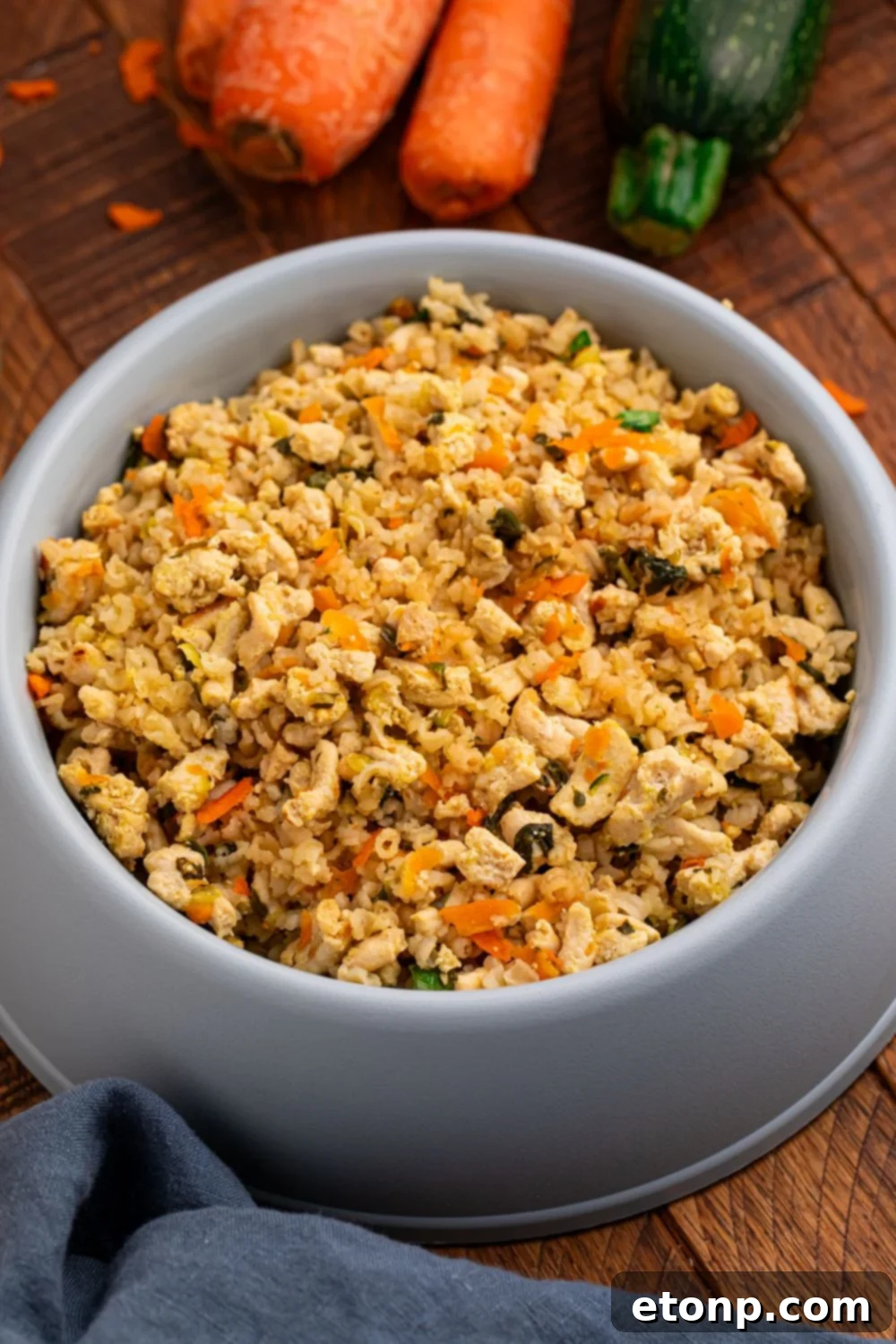 overhead look of homemade dog food in a grey bowl on table 