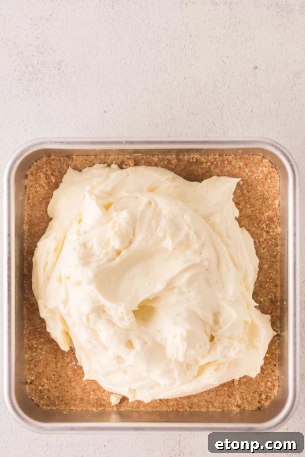 crust with cheesecake filling placed on top of crust 