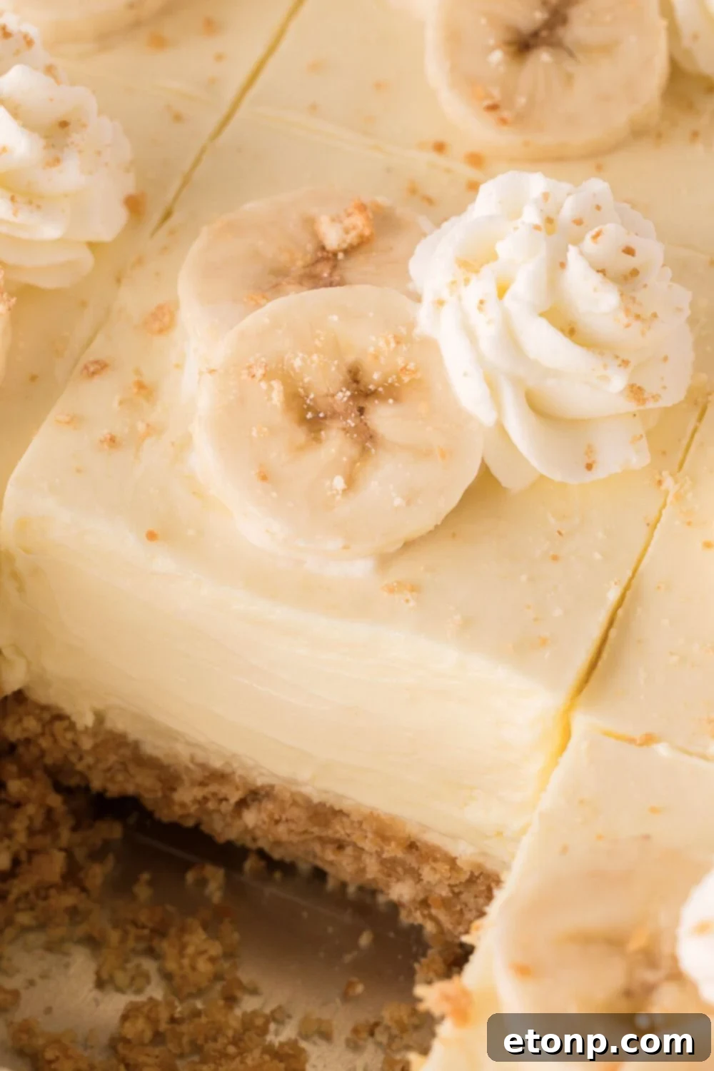close up of sliced No Bake Banana Pudding Cheesecake Bars in a pan 