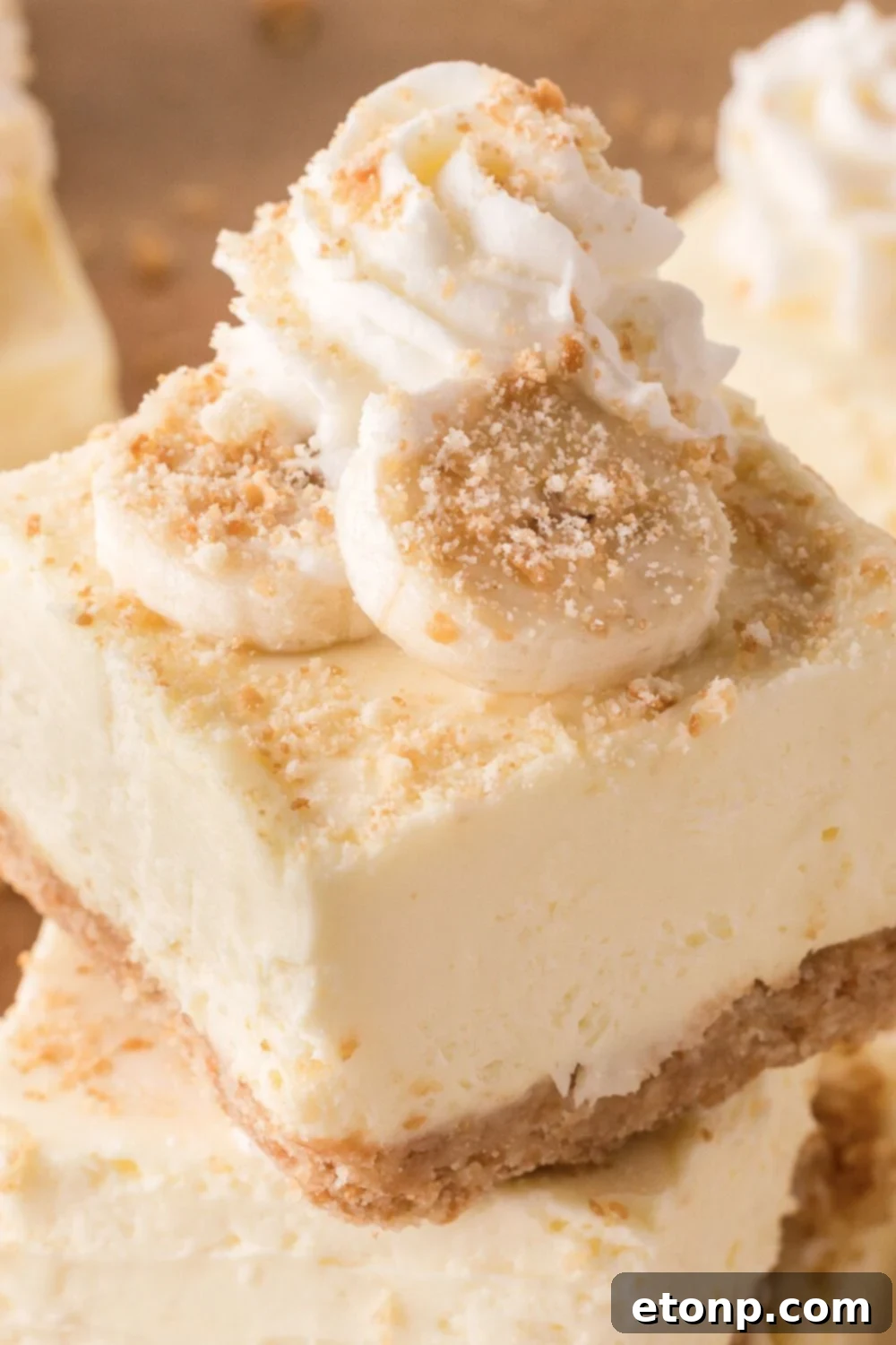 close up of No Bake Banana Pudding Cheesecake Bars stacked on a plate 
