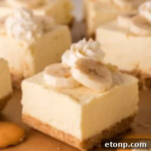 No Bake Banana Pudding Cheesecake Bars sliced and placed on table with vanilla wafers around table