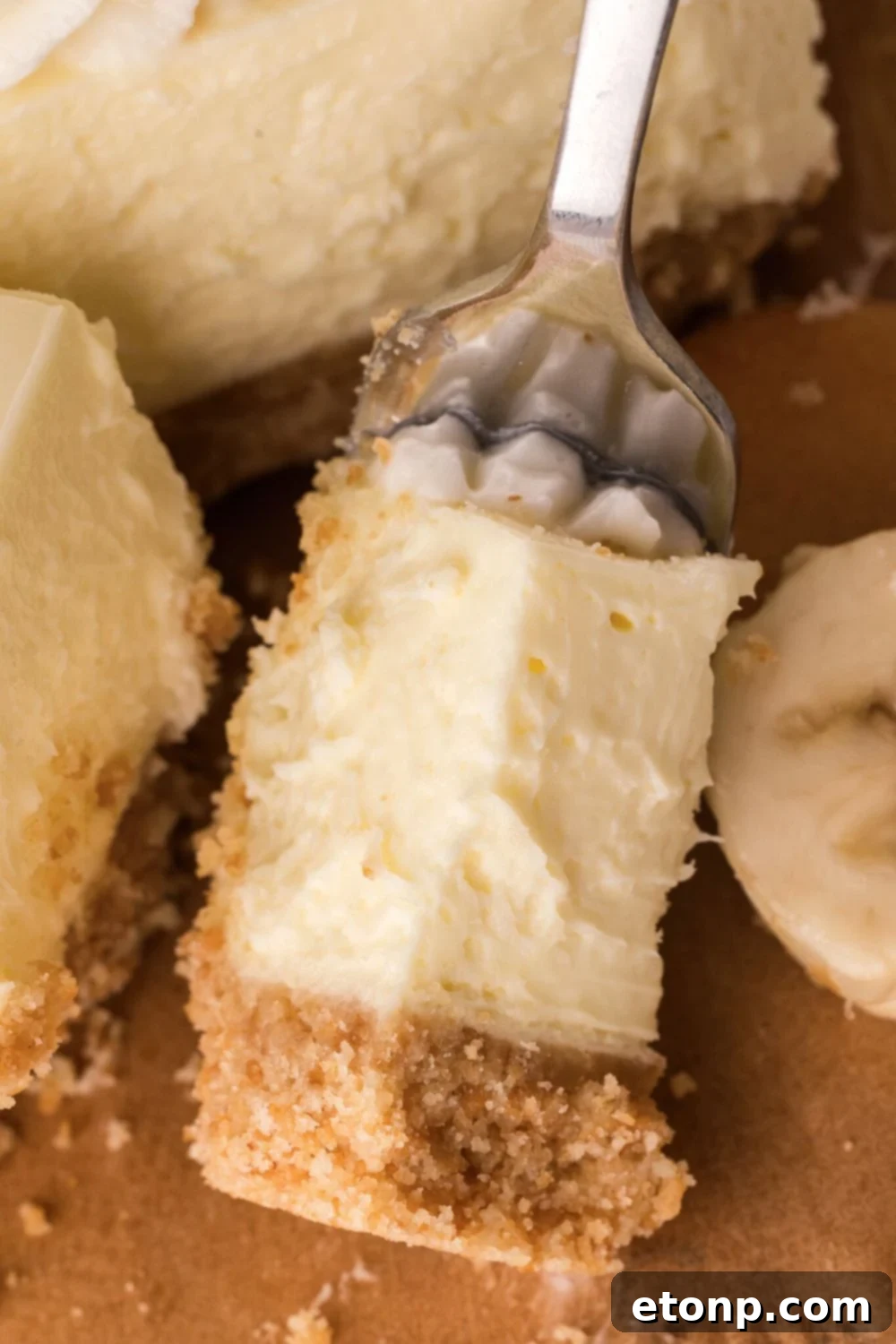 fork with a bite of No Bake Banana Pudding Cheesecake Bar on it 