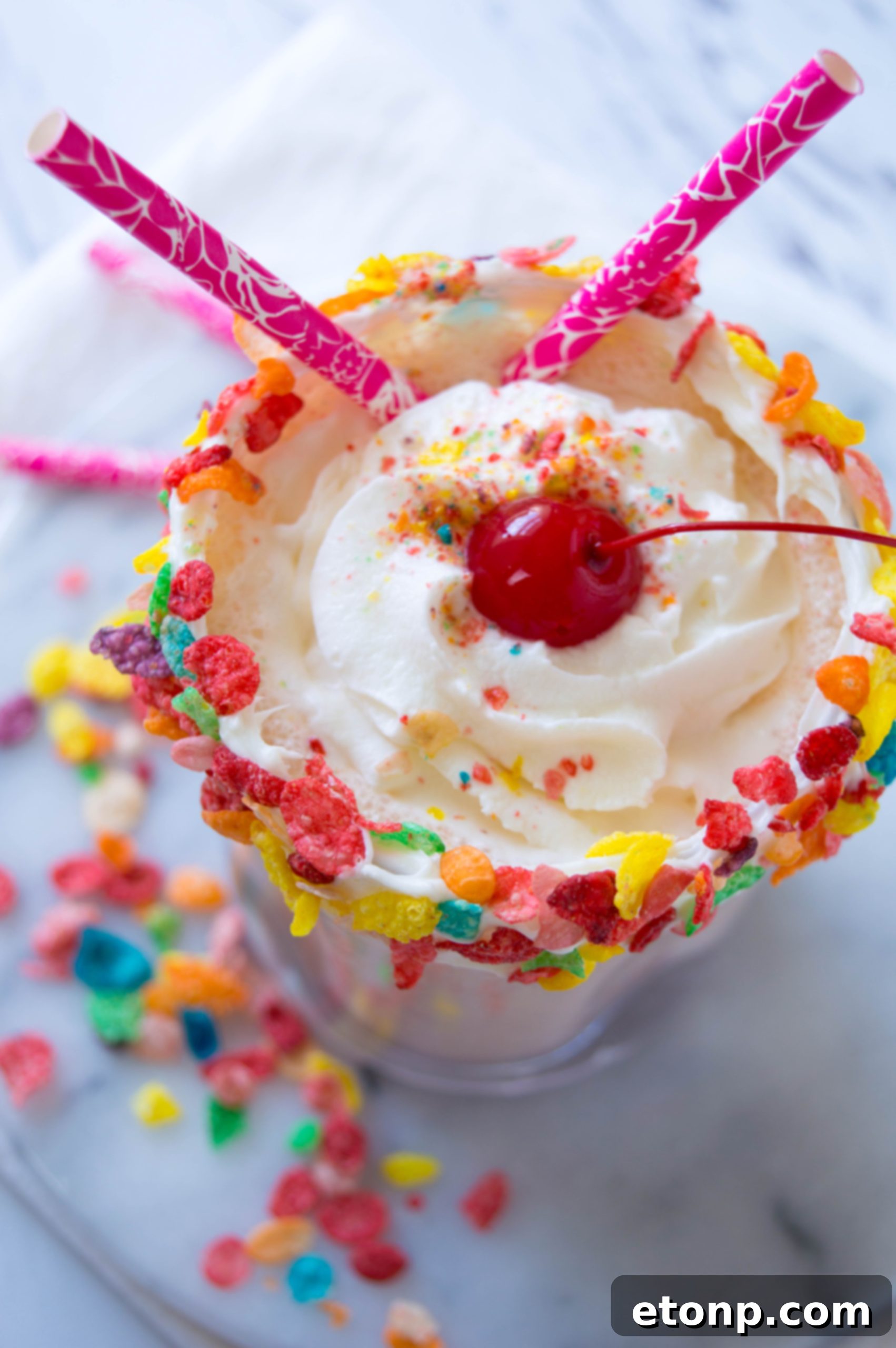 Close-up of the creamy texture of the Fruity Pebbles Milkshake, ready for a sip