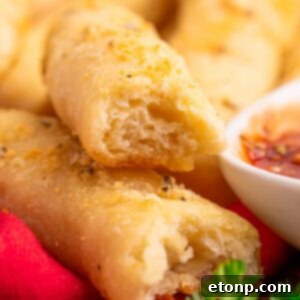 Easy Buttery Garlic Parmesan Breadsticks Two Ingredients 25 2 Ingredient Garlic Parmesan Breadsticks on table with one torn in half