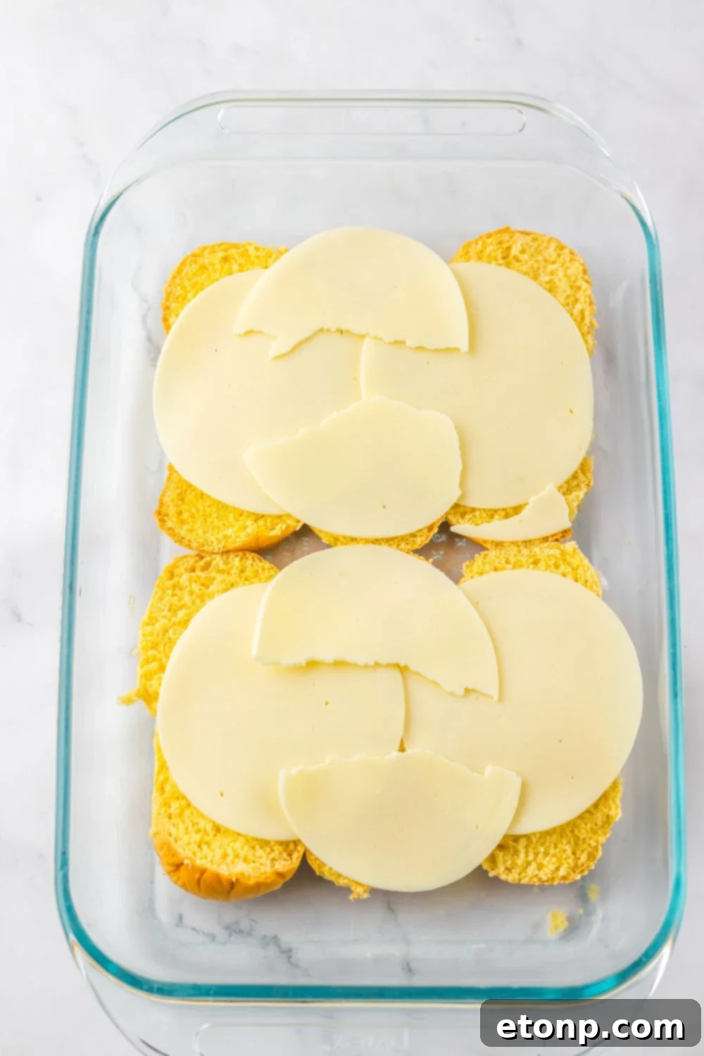 rolls with provolone cheese spread over the top of the buns 