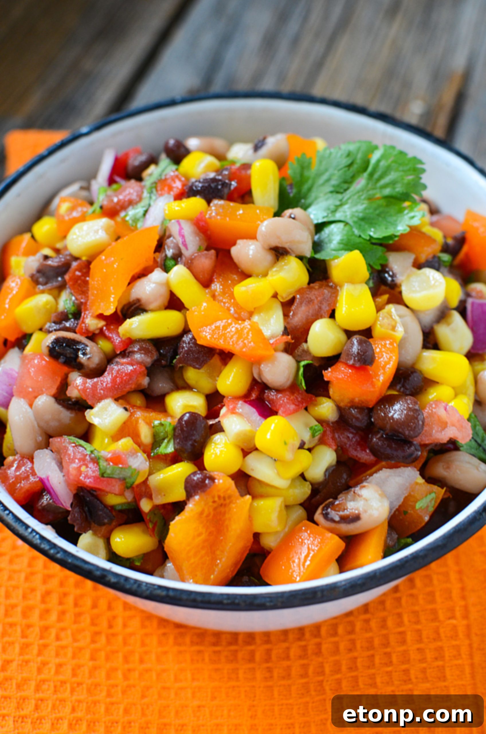 A small bowl of homemade Cowboy Caviar dressing, showing its vibrant color and smooth texture.