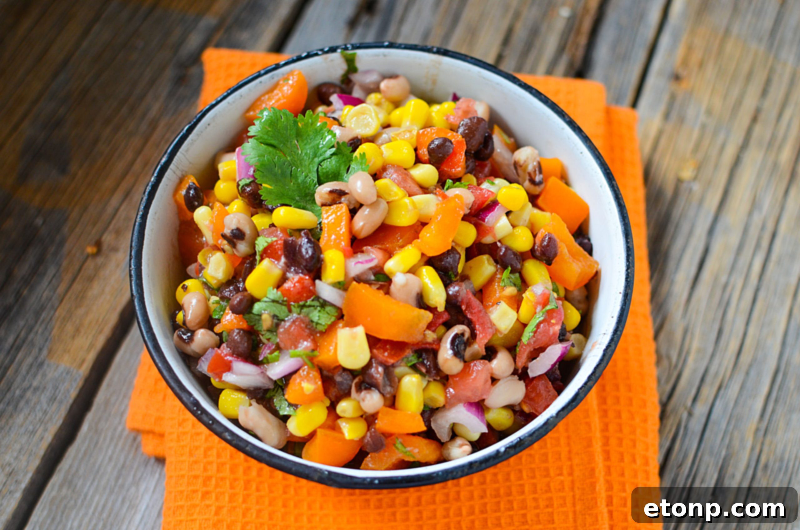 A bowl of freshly mixed Cowboy Caviar with the dressing, showing vibrant colors and fresh ingredients.