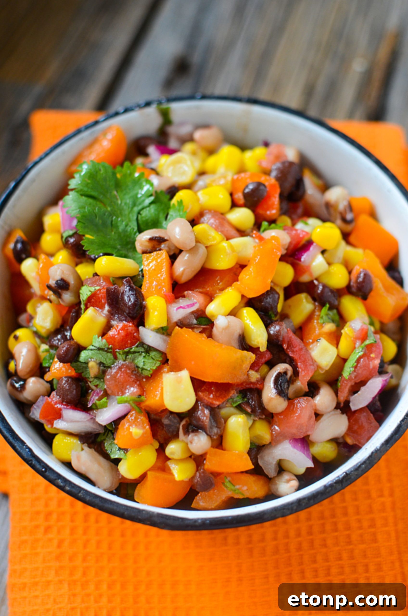 A large serving bowl overflowing with Cowboy Caviar, ready for a party.