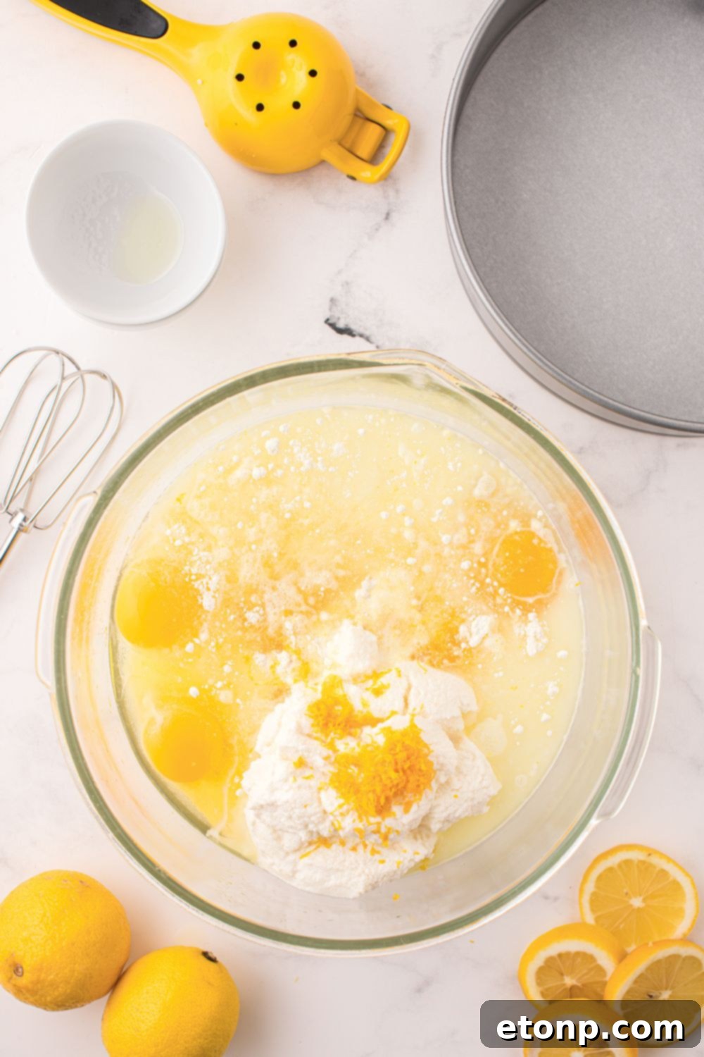 Effortless Italian Lemon Ricotta Cake: Light and Lemony Perfection 8 All the wet ingredients for the Lemon Ricotta Cake are combined in a clear glass bowl, showcasing their creamy texture before mixing.