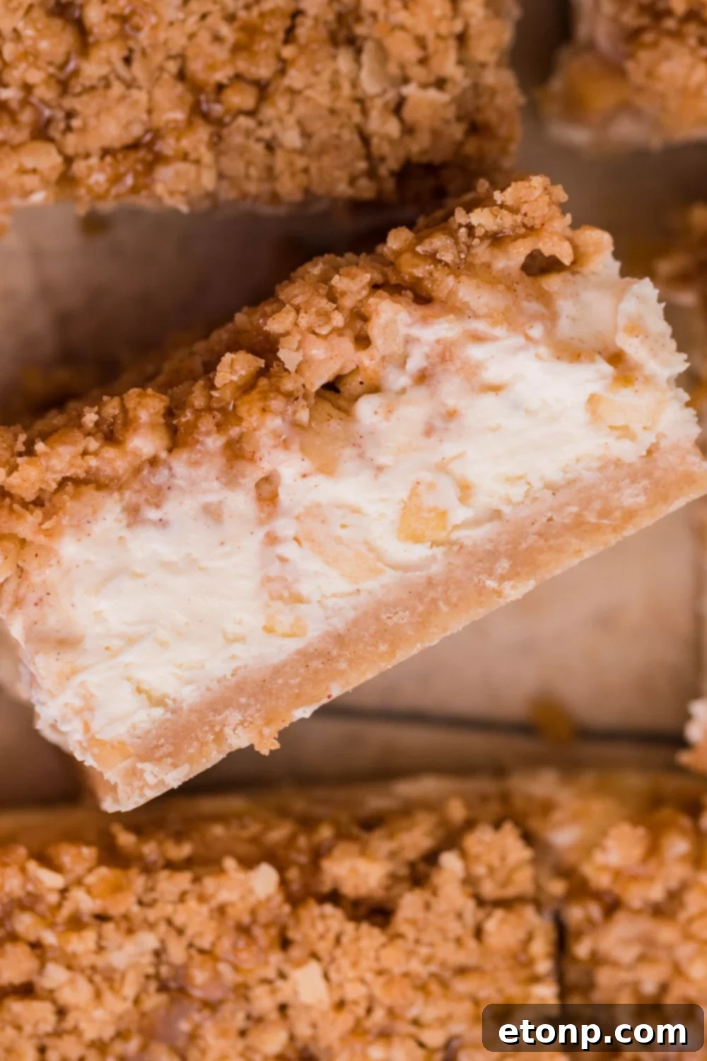 Caramel Apple Cheesecake Bar on its side on table with more placed around it on table