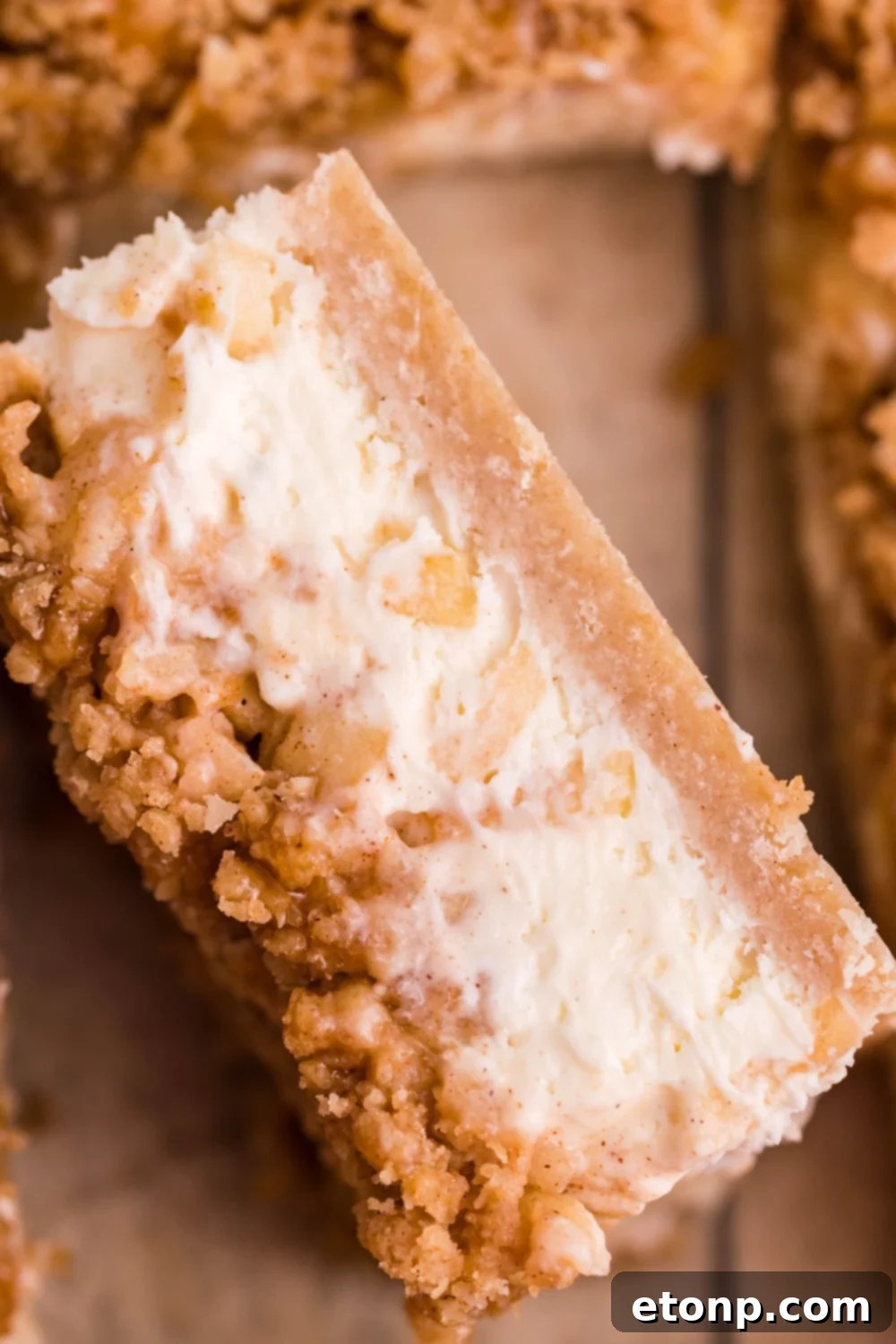 Caramel Apple Cheesecake Bar on its side showing the layers