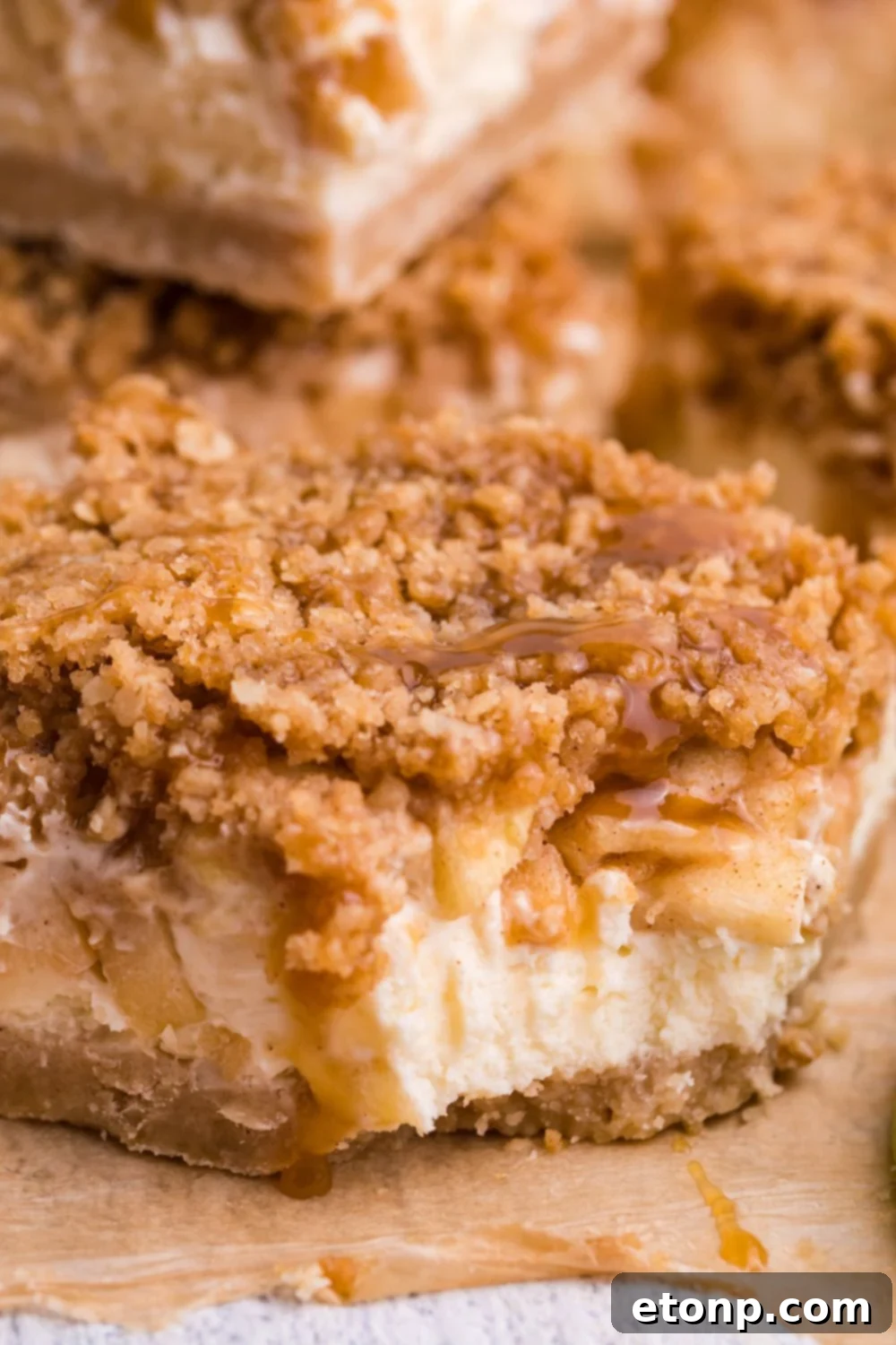 Caramel Apple Cheesecake Bar on table with a bite taken out of it