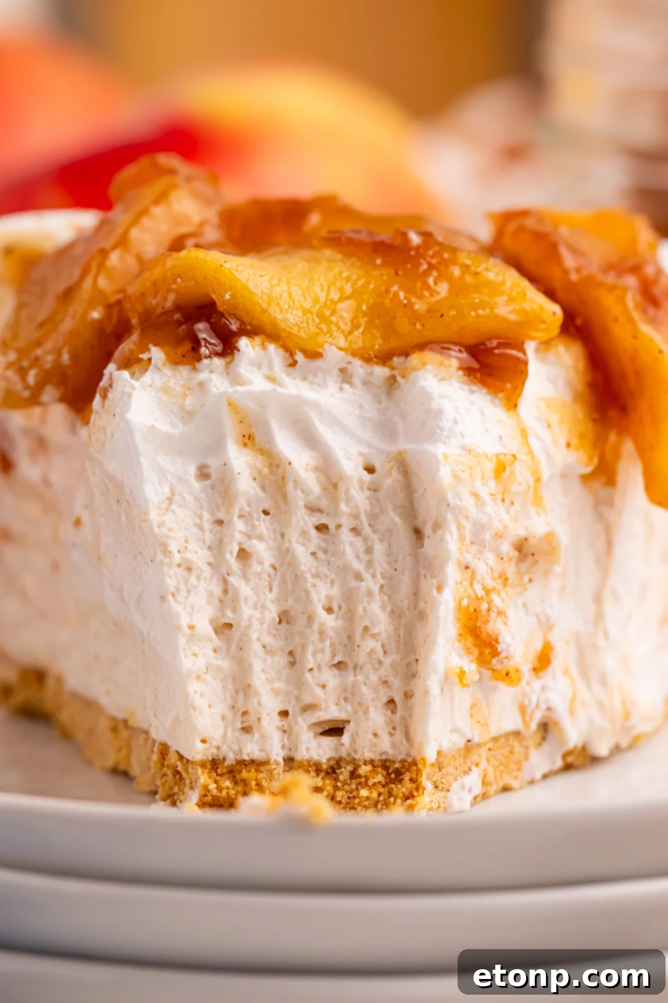 No Bake Apple Cheesecake pie slice up close with a big bite missing 