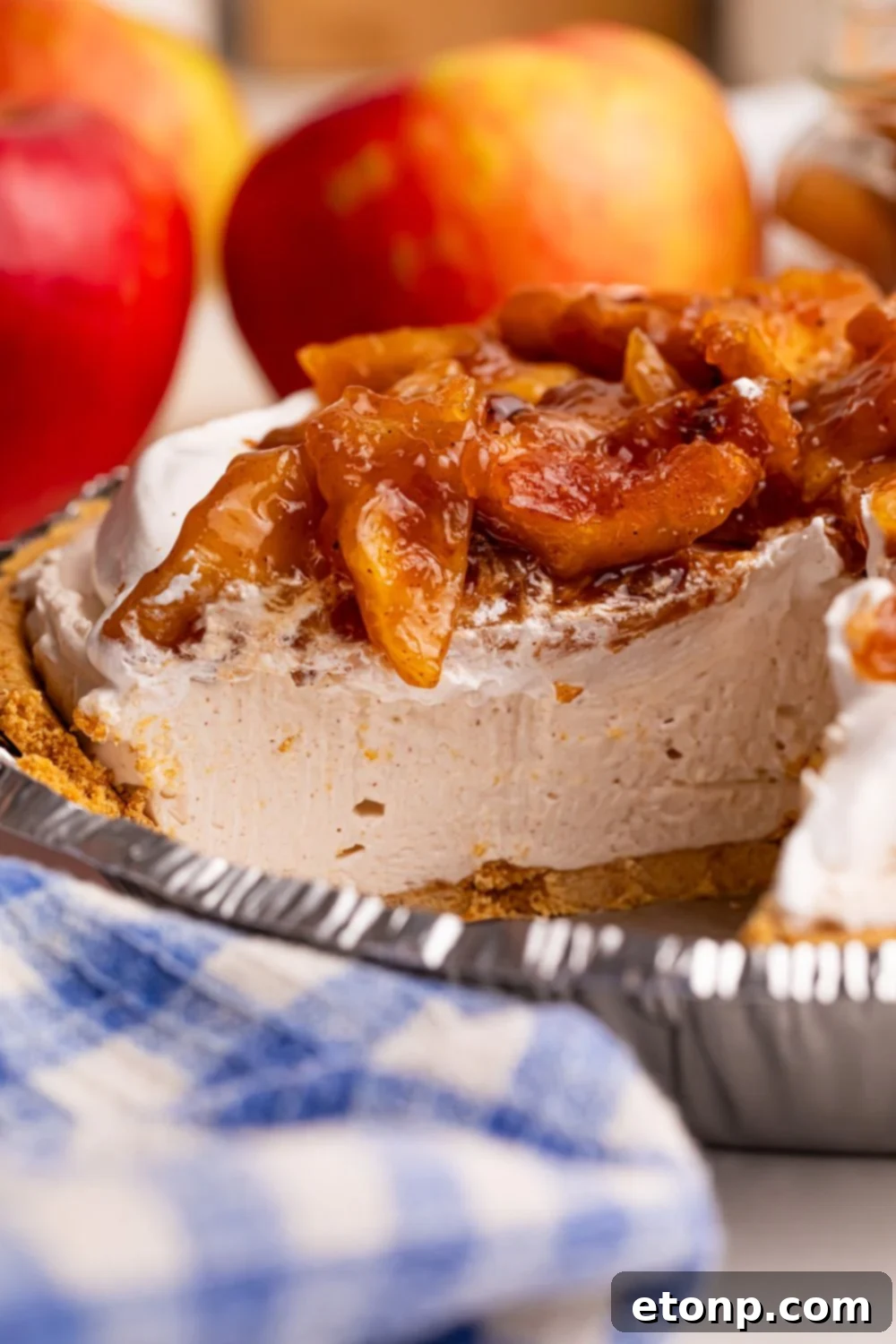 view of No Bake Apple Cheesecake pie with a slice missing out of it 
