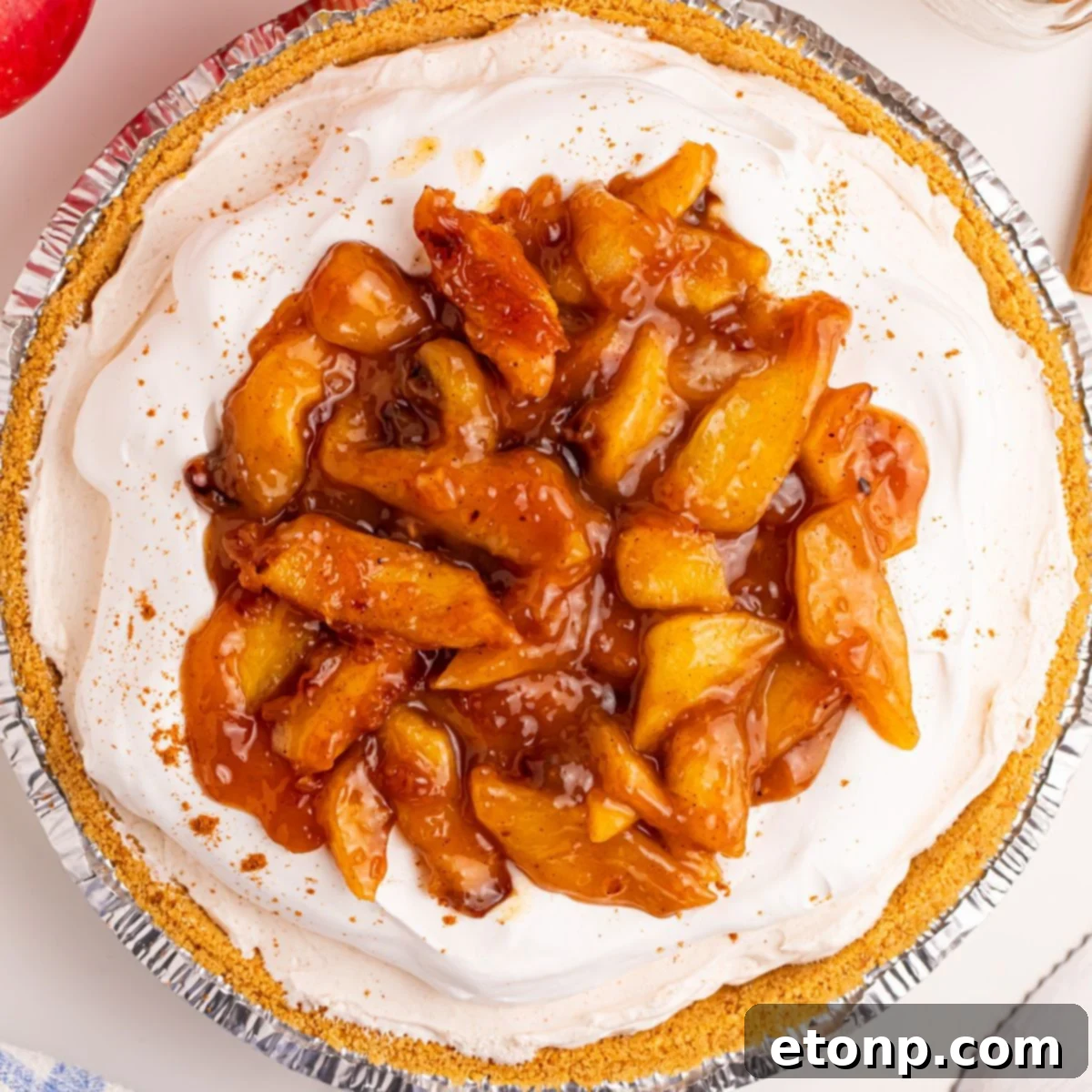 No Bake Apple Cheesecake pie on table in pie pan 