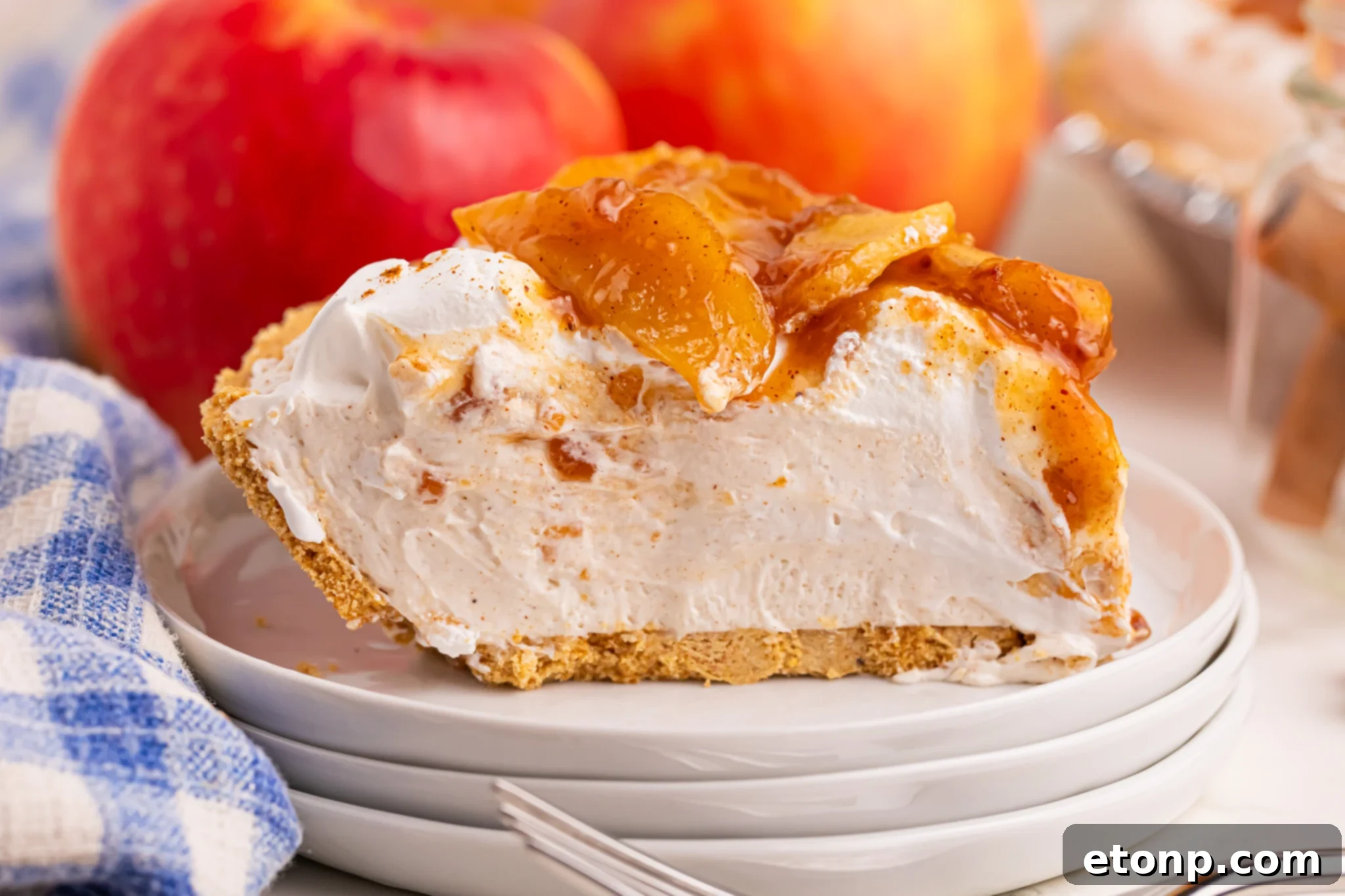 No Bake Apple Cheesecake pie slice on a pile of white plates