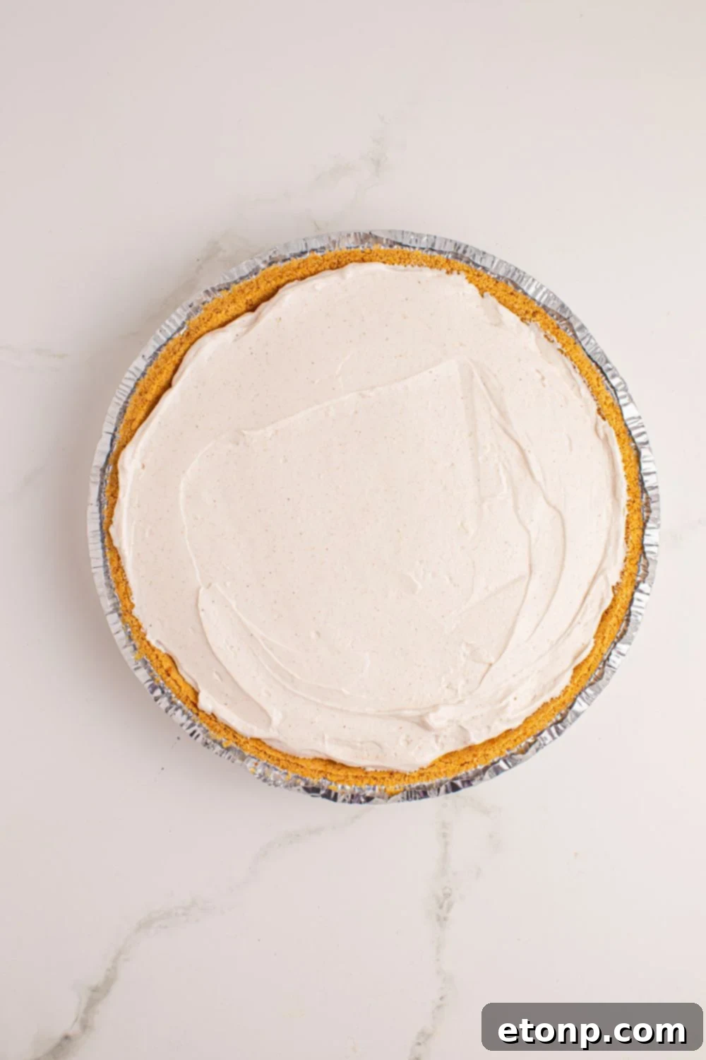 assemble of No Bake Apple Cheesecake in pie 