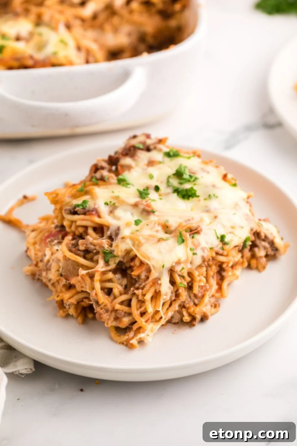 Million Dollar Spaghetti Casserole on a plate sitting on table 