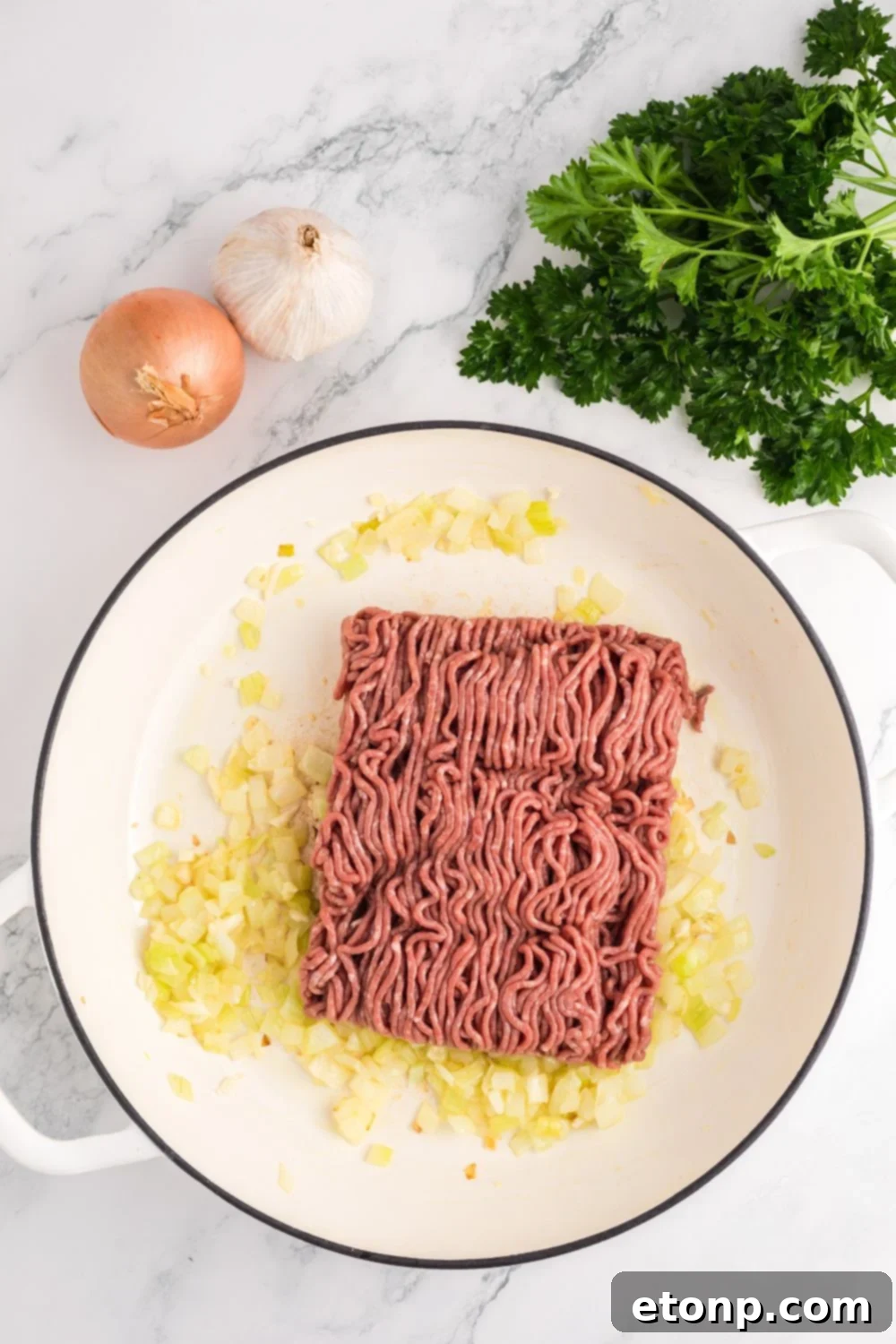 sauted onions with ground beef in pan 