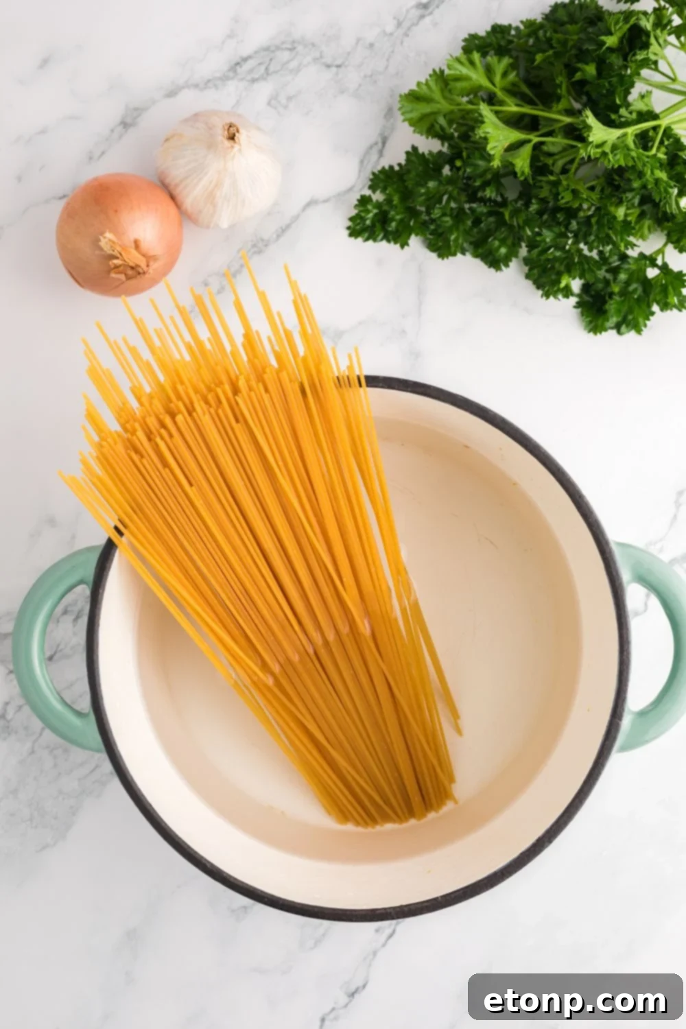 pot with water with dry pasta in it on table 