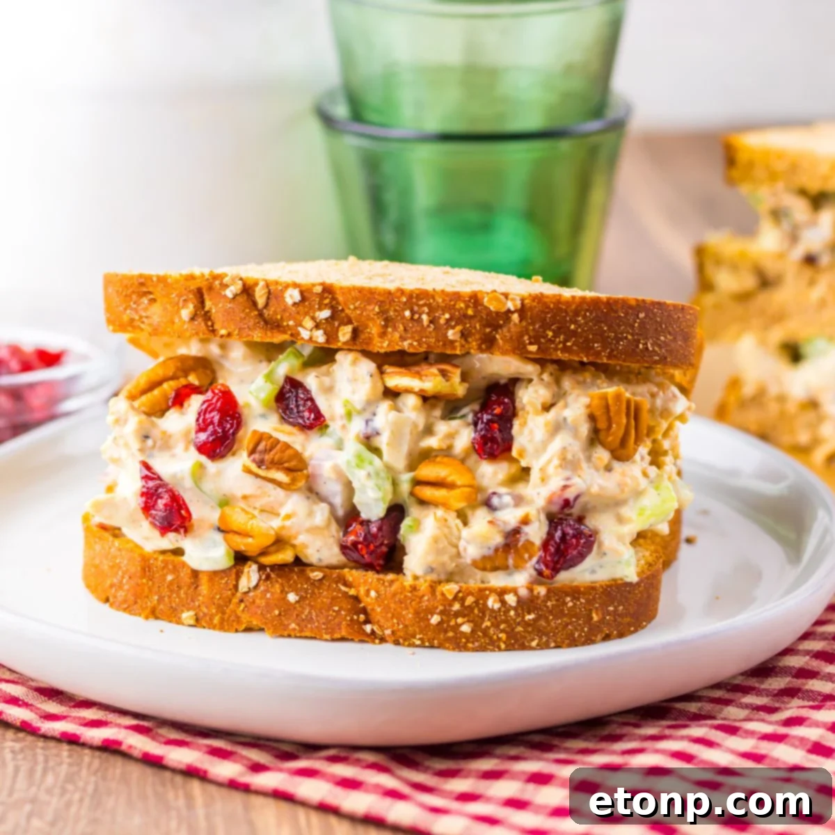 Thanksgiving Turkey Salad sandwich on plate with glasses and milk behind it on table 