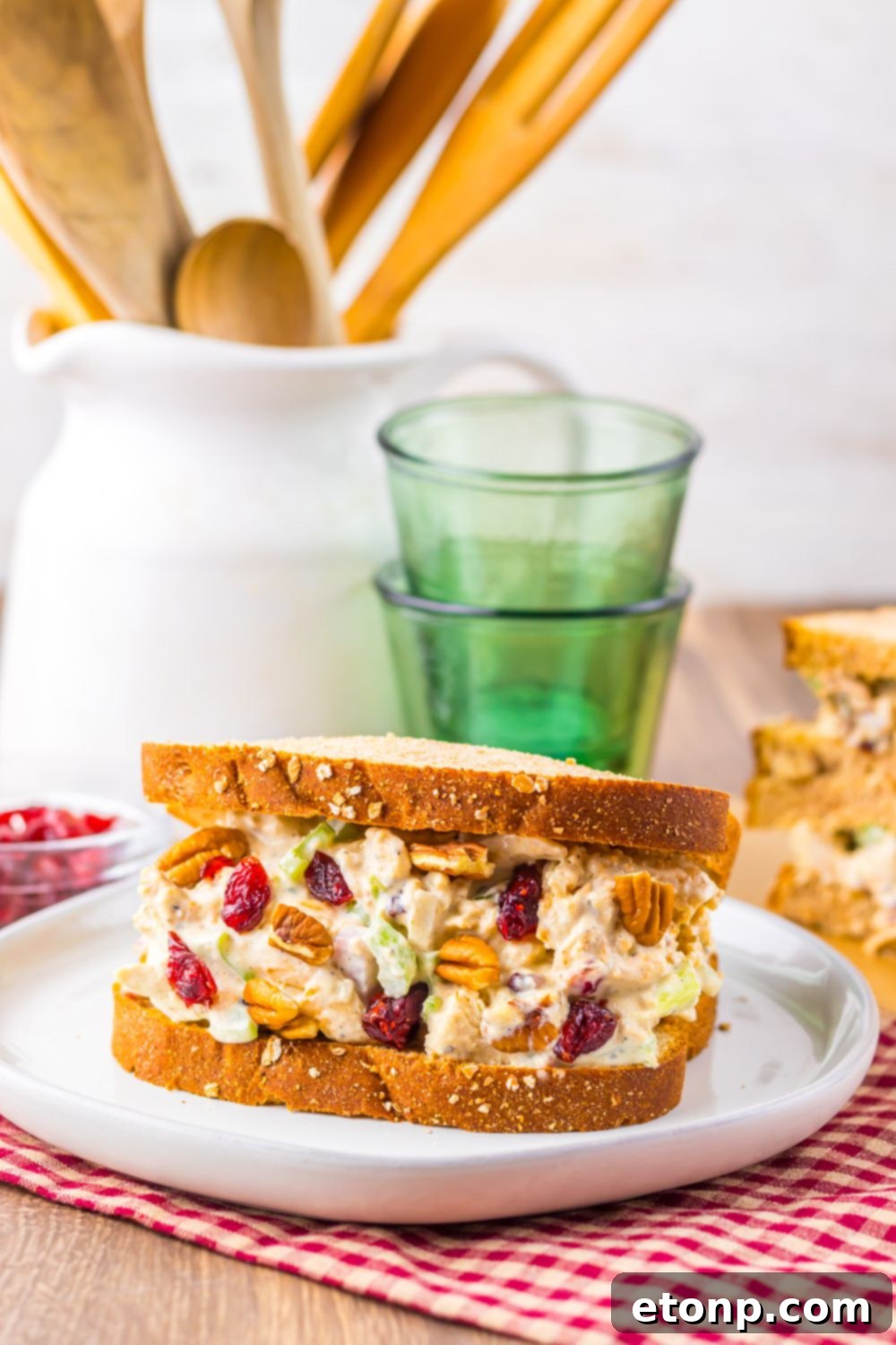 Thanksgiving Turkey Salad on plate with some glasses behind it on table 