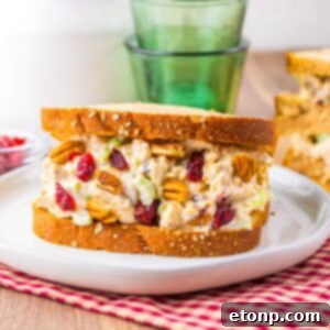 Thanksgiving Turkey Salad sandwich on plate with glasses and milk behind it on table