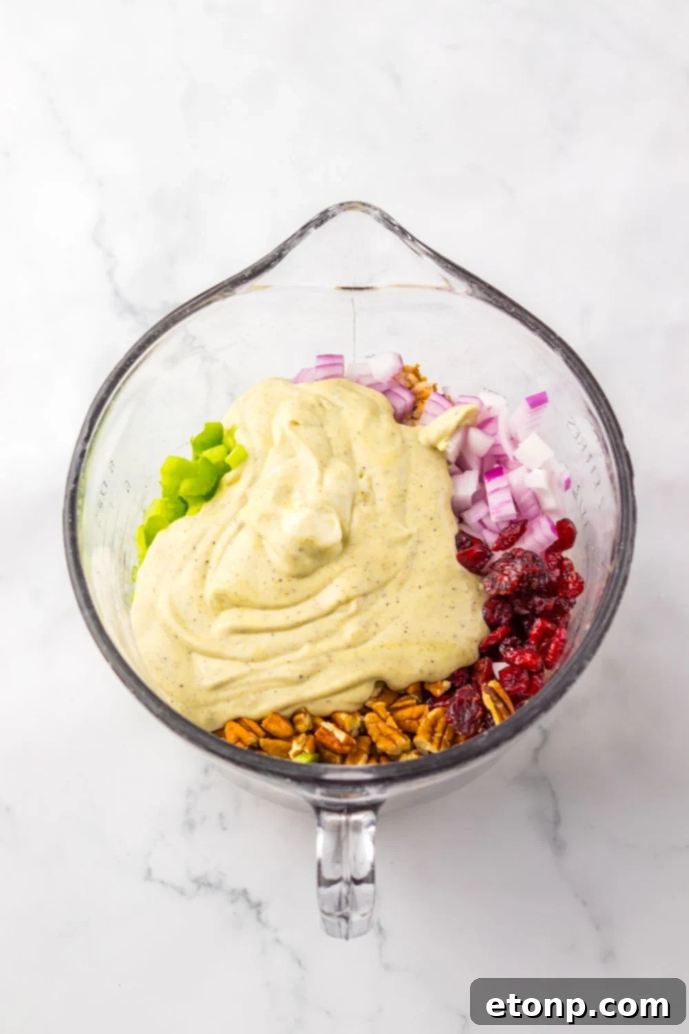 Thanksgiving Turkey Salad mixture in a measuring cup being mixed up
