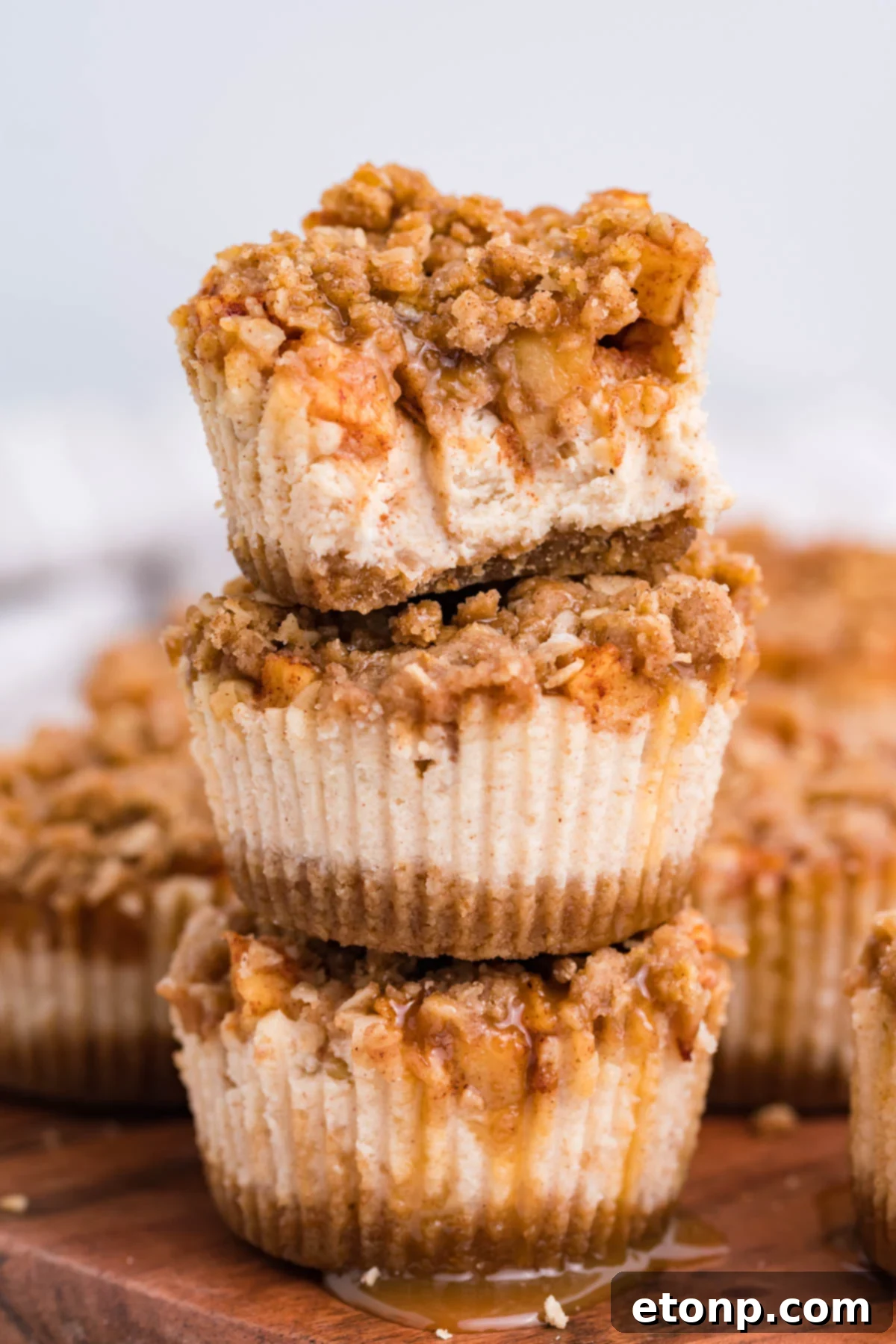 Stack of 3 Apple Crisp Cheesecakes with a bite missing from the top one