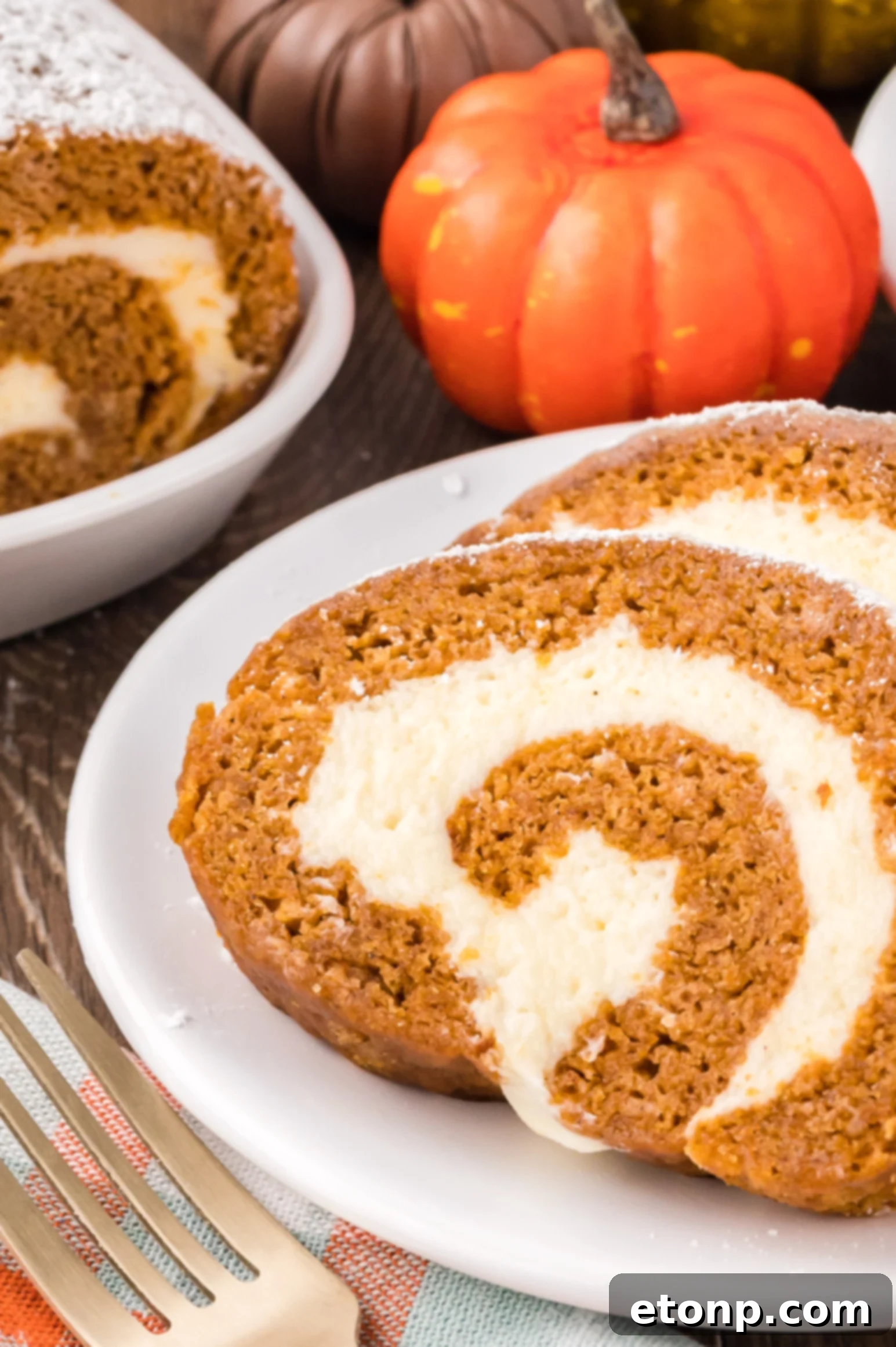 Slices of the Pumpkin Cake Roll on a white plate