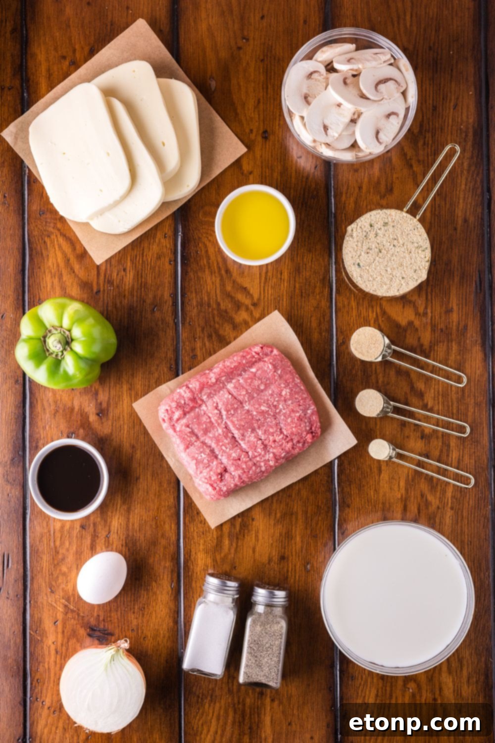 Cheesy Philly Stuffed Meatloaf with Peppers and Onions 5 a wooden table topped with all the ingredients in single serve containers to make Stuffed Philly Cheesesteak Meatloaf