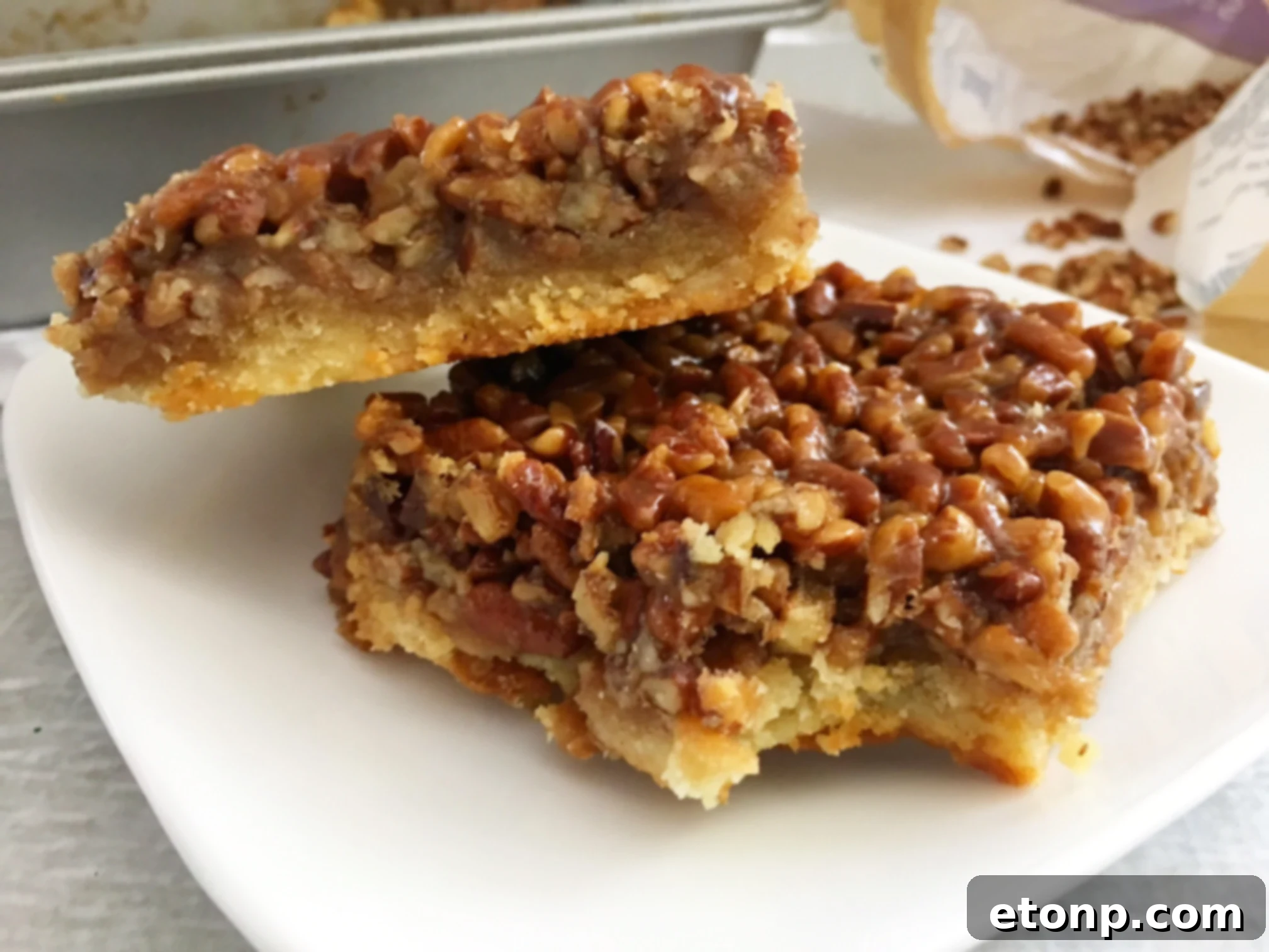 Pecan Pie Bars cooling on a wire rack after baking, showing their perfect golden crust.