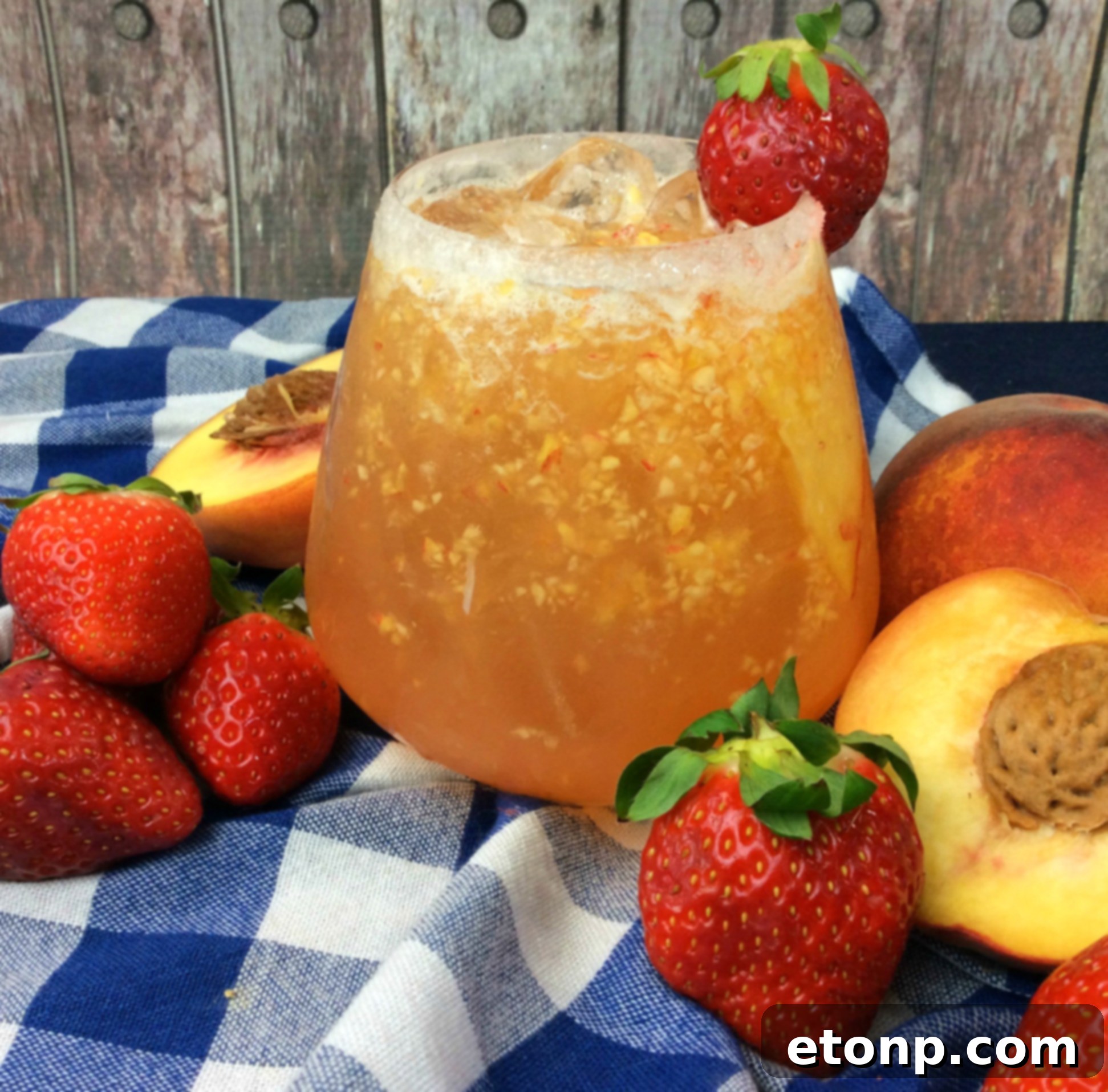 Close-up of a Naughty Georgia Peach Cocktail, garnished with fresh peach slices