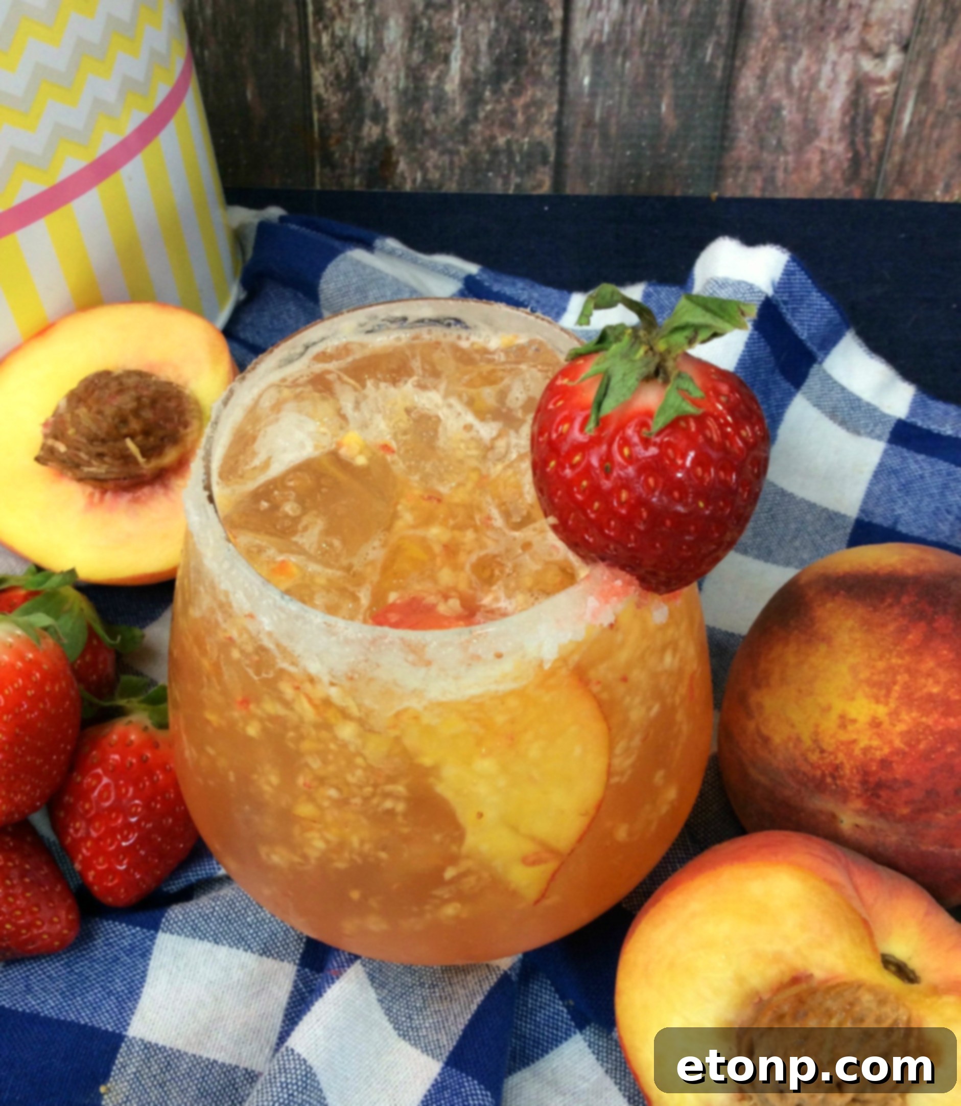 Two glasses of Naughty Georgia Peach Cocktail on a rustic background