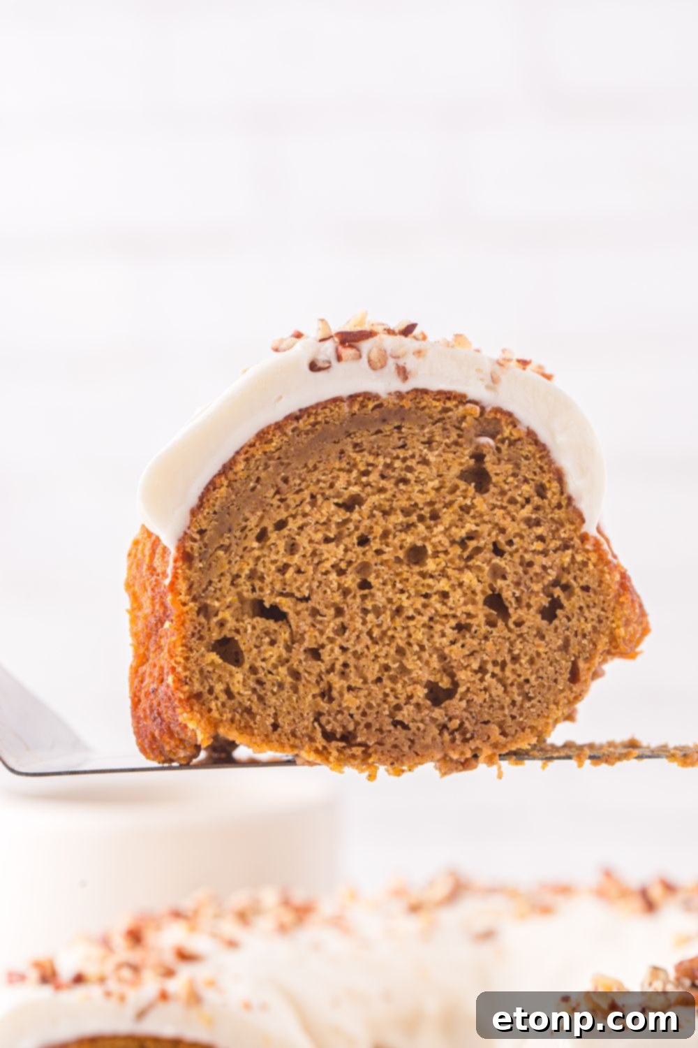 slice of Pumpkin Bundt Cake on a spatula 